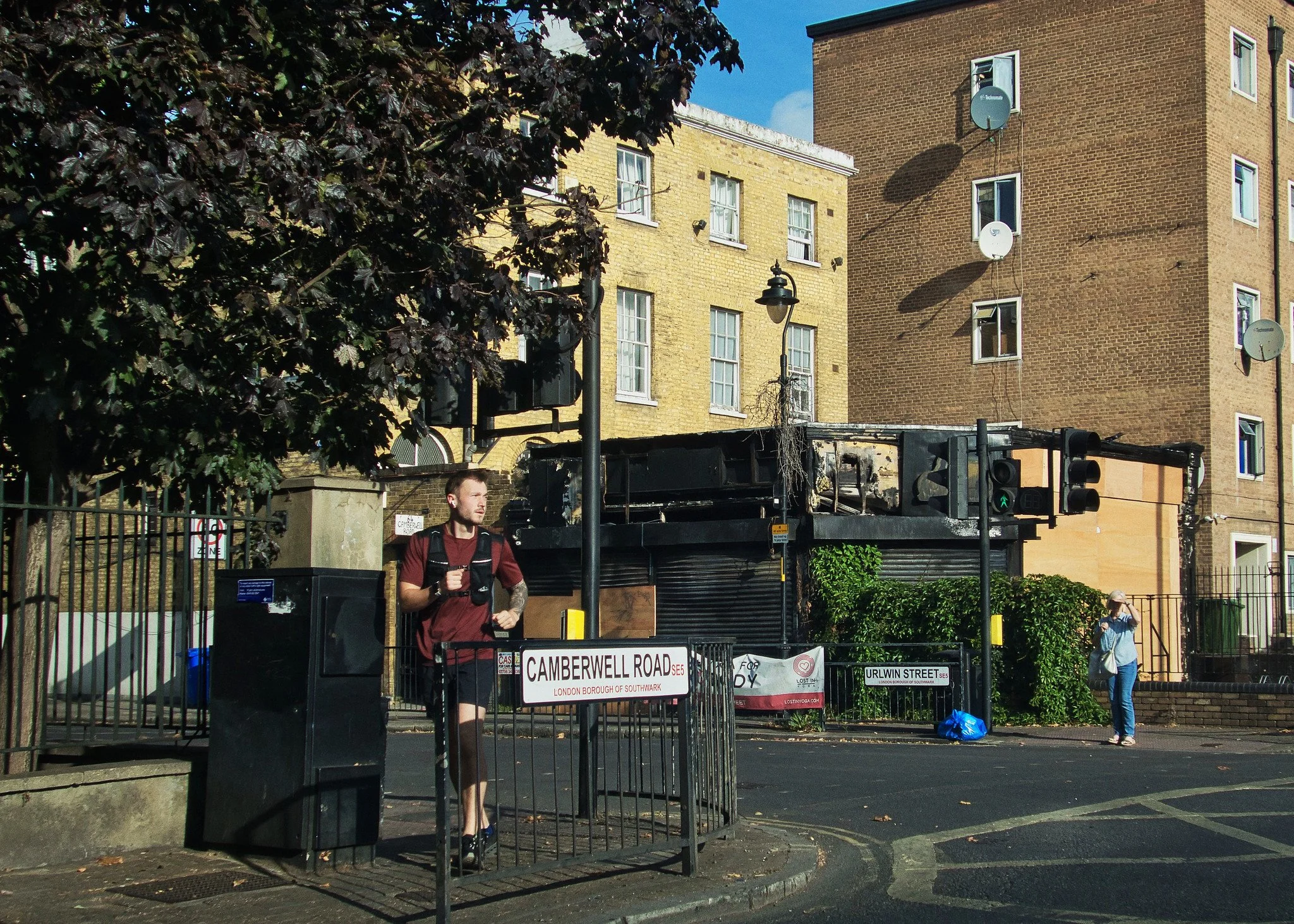 Runner on Camberwell Road (burnt-out shop)