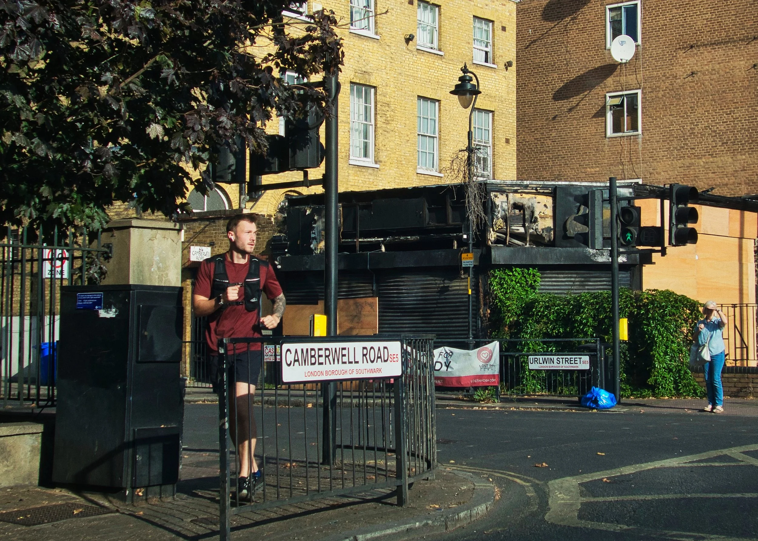 Runner on Camberwell Road (burnt-out shop)