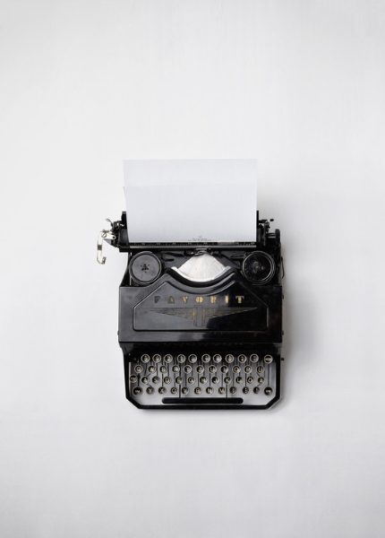 A vintage typewriter set in the center of a white space. Writer's block?