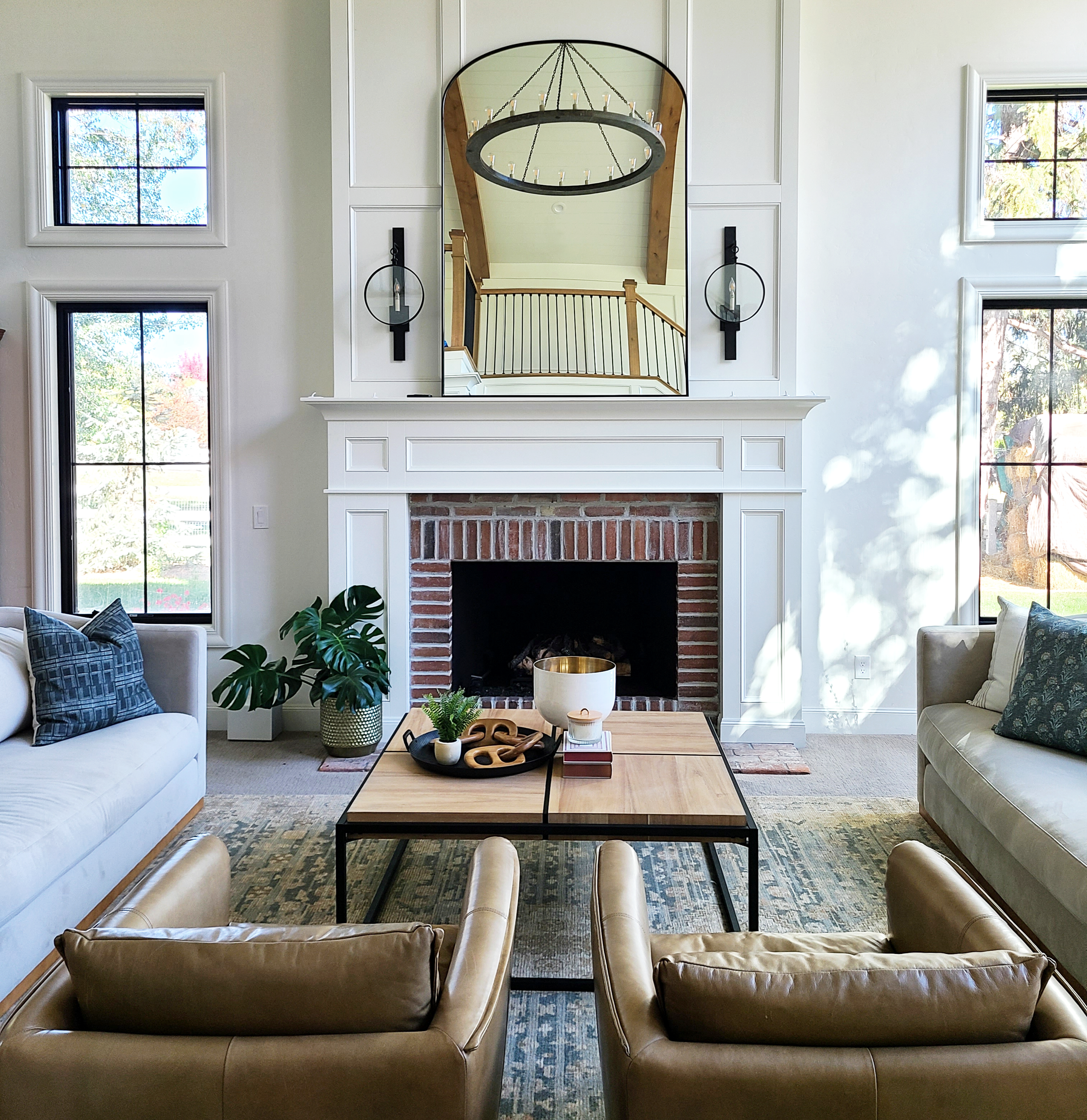 Modern living room with a brick fireplace and black lighting designed by Liz Powell Design in Logan, UT. modern living room designs #lizpowelldesign #diyhomeupdates #budgethomeupdates #affordableDIY #modernhomedesign #Cachevalleyinteriordesigner