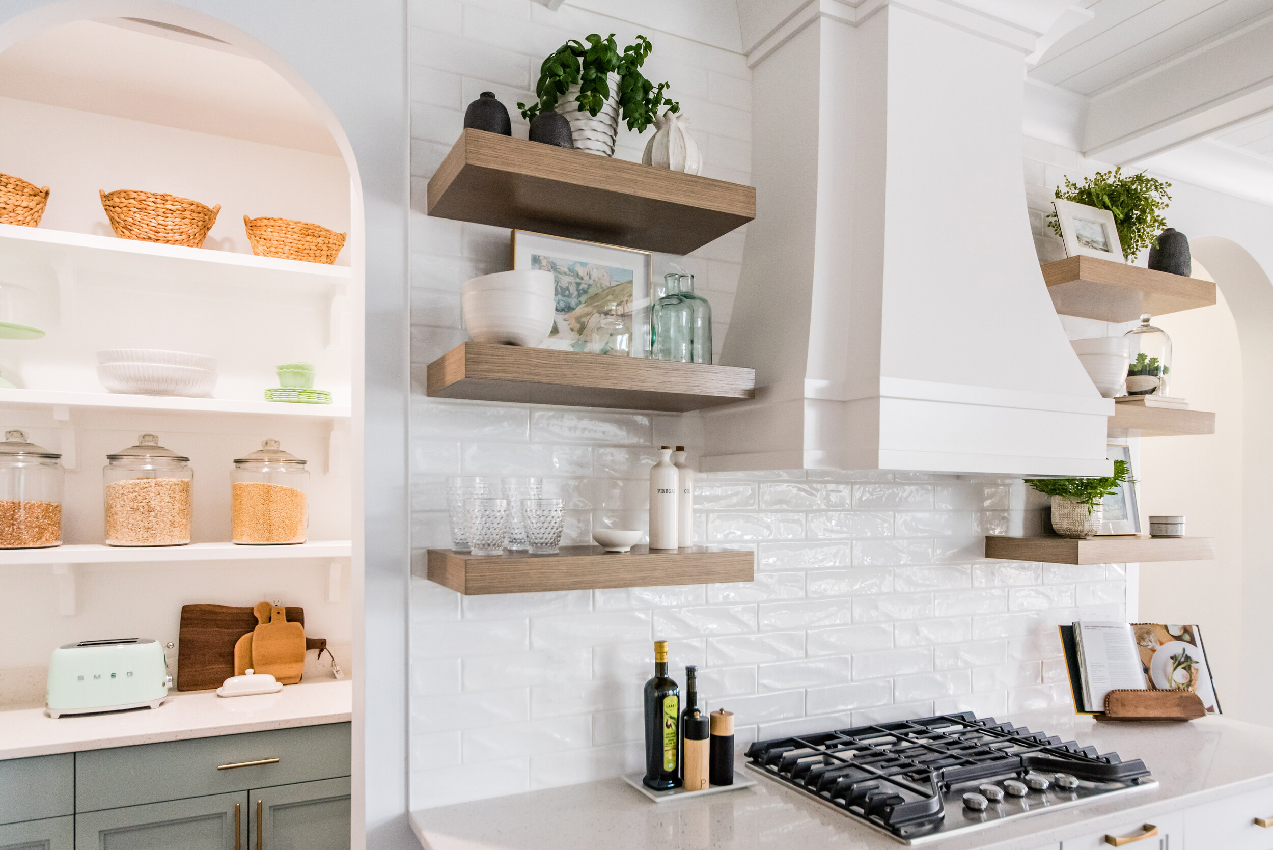  Photo of a kitchen with open shelving, white subway tile, and white stove top range in Cache County designed by Liz Powell Design. french country open shelving basket containers in kitchen white stove top range #lizpowelldesign #lizpowelldeisgns #in