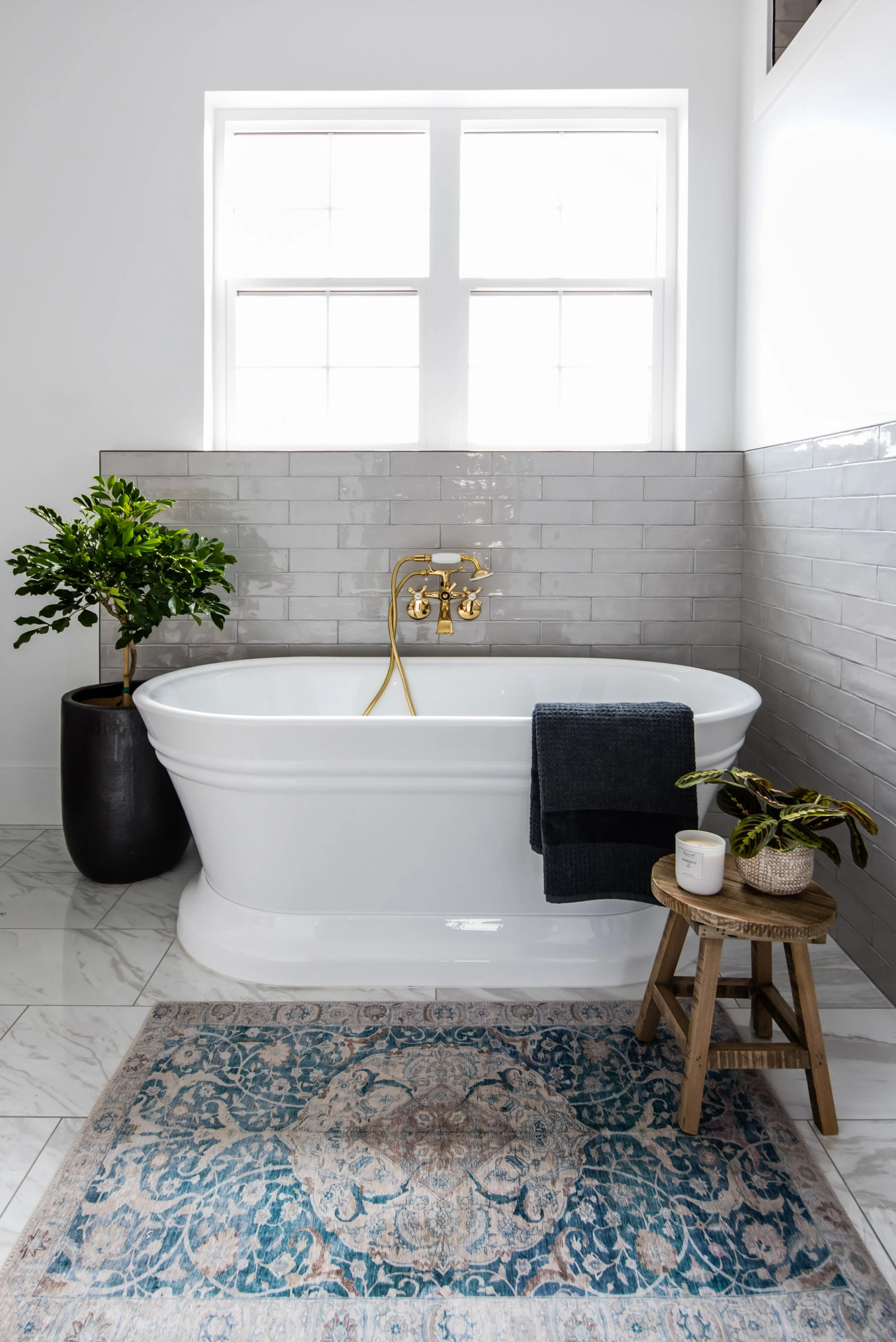 Northern Utah interior designer Liz Powell Design features a bathroom with a window above it. tub designs timeless tub #lizpowelldesign #cachevalleyinteriordesigners #springcleaning #housetips #interiordesignersnothernutah #utahhousedesigners