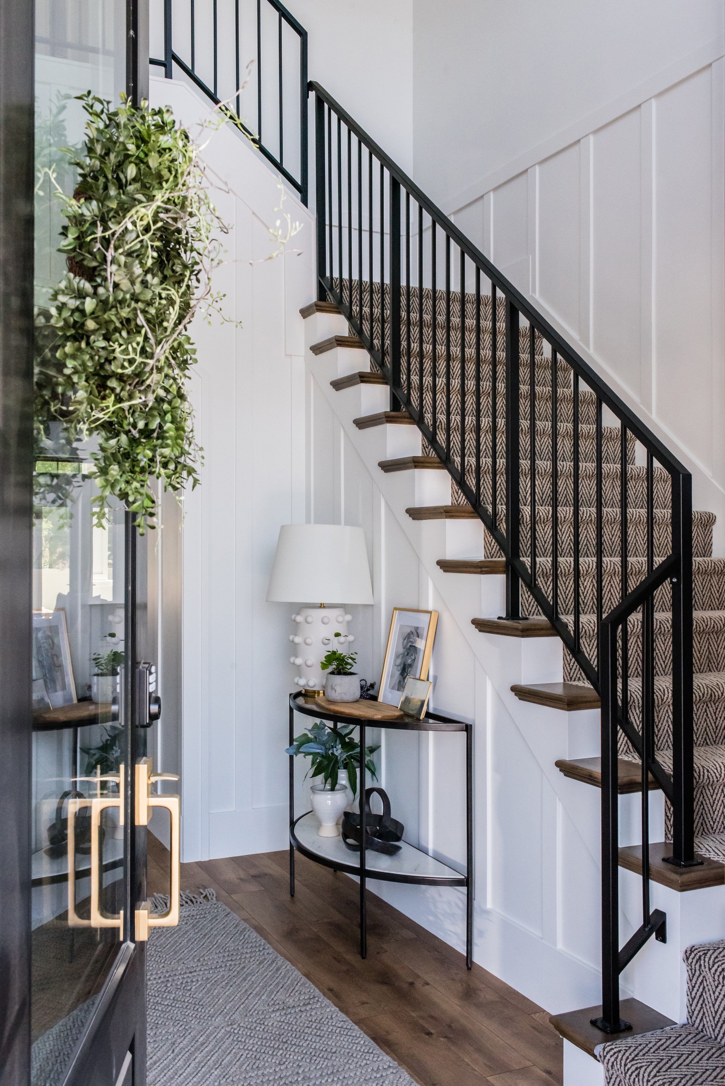  The open design of this foyer uses the stairway to draw the eyes upward and focus on the high ceilings and openness of the room. Open design foyer exposed staircase black and white #opendesignstairway #unobstructedview #grandstaircase 
