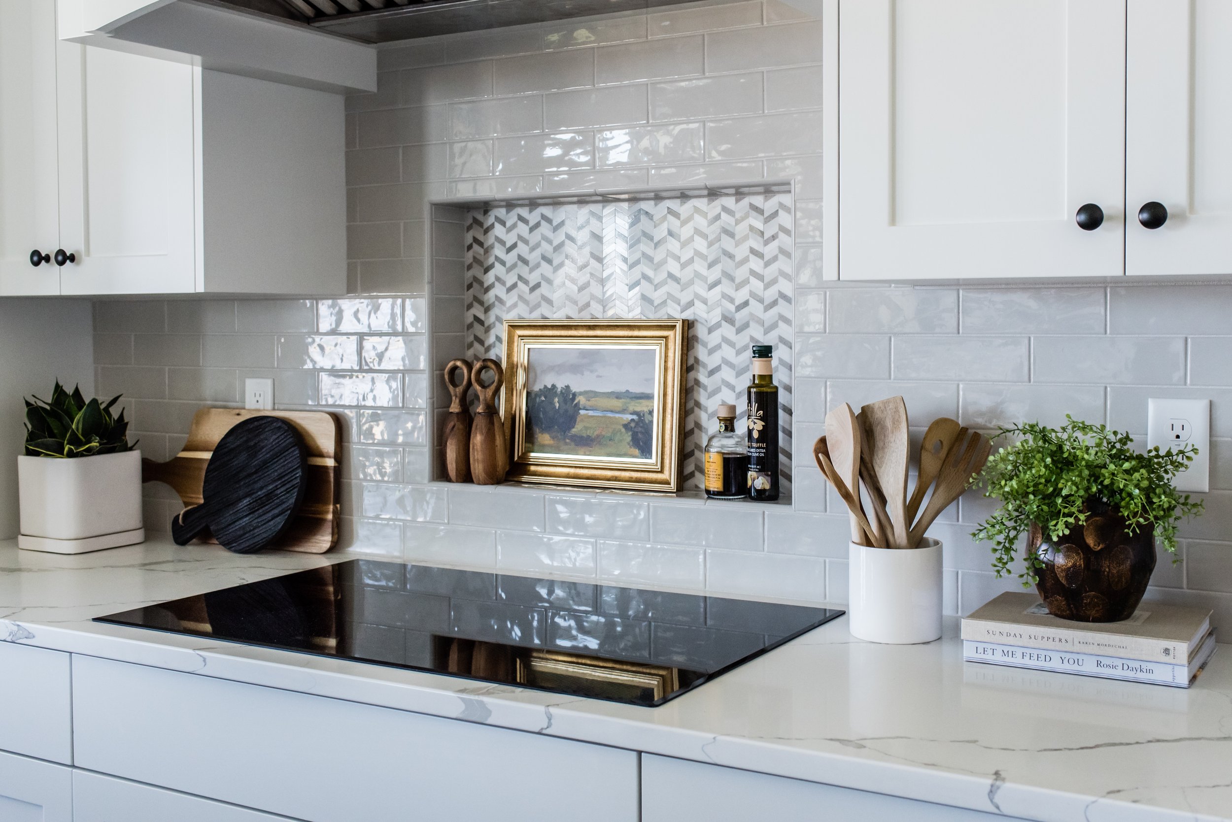  Chevron pattern tile draws focus to the recessed part of the backsplash and is a perfect statement piece for this white kitchen. Recessed backsplash white kitchen Liz Powell Hyde Park Utah #recessbacksplash #whitekitchen #architecturestatementpiece 