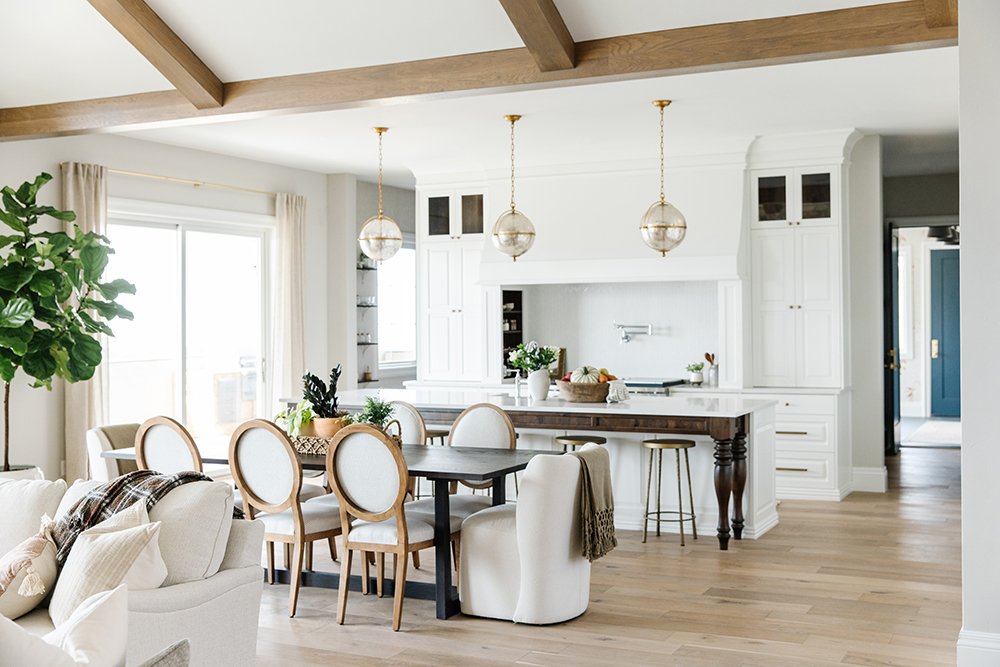  The open concept of this kitchen and dining area makes the house feel open. The direction of the exposed beams flows with the direction of the dining table and island. #exposedbeams #openconceptkitchen #whiteandwoodkitchen 