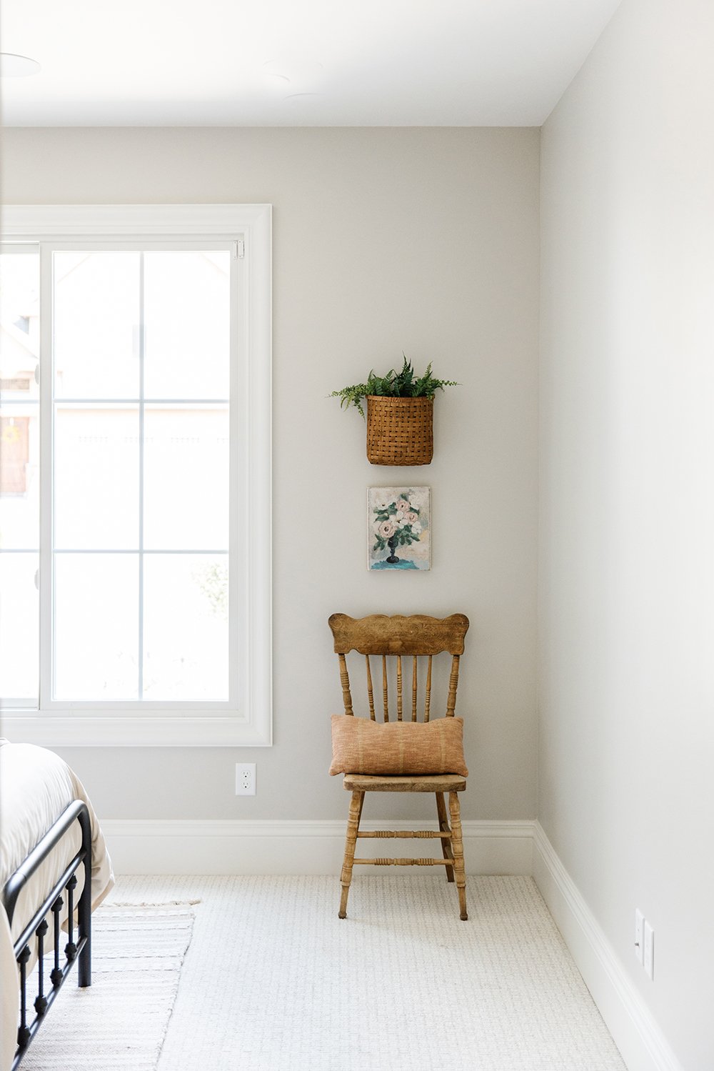  Using an antique chair as a statement piece, Liz Powell uses that as a starting point for other decoration colors and styles. The basket and floral print pair well with the chair and the wall colors. Antique chair woven basket #neutralpaint #antique