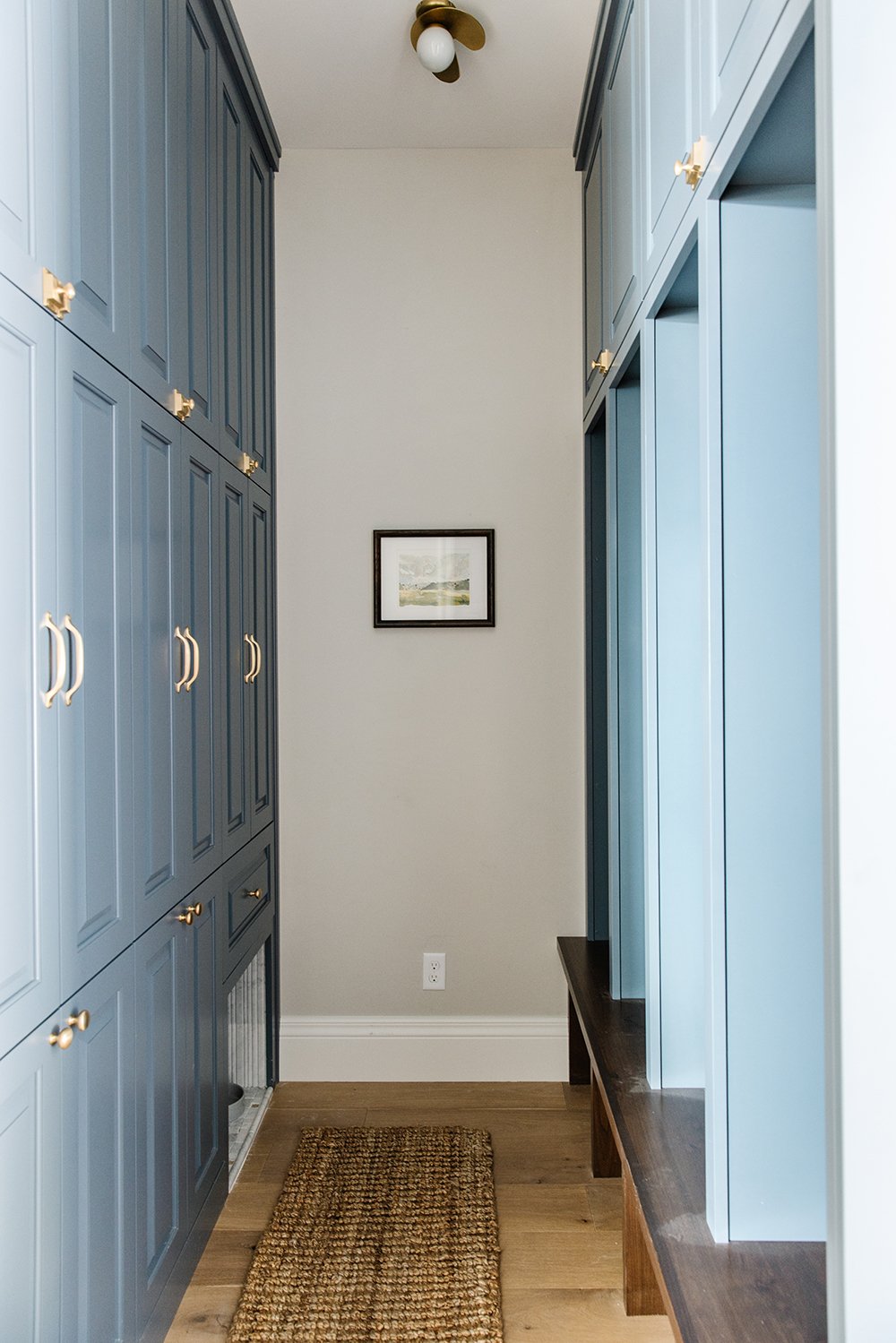  Small mudrooms can still be fully functional like this one designed by Liz Powell. The bright blue color adds personality to this room. Blue mudroom lockers small mudroom personal lockers #mudroomlockers #bluemudroom #blueanddarkwalnut #goldhardware