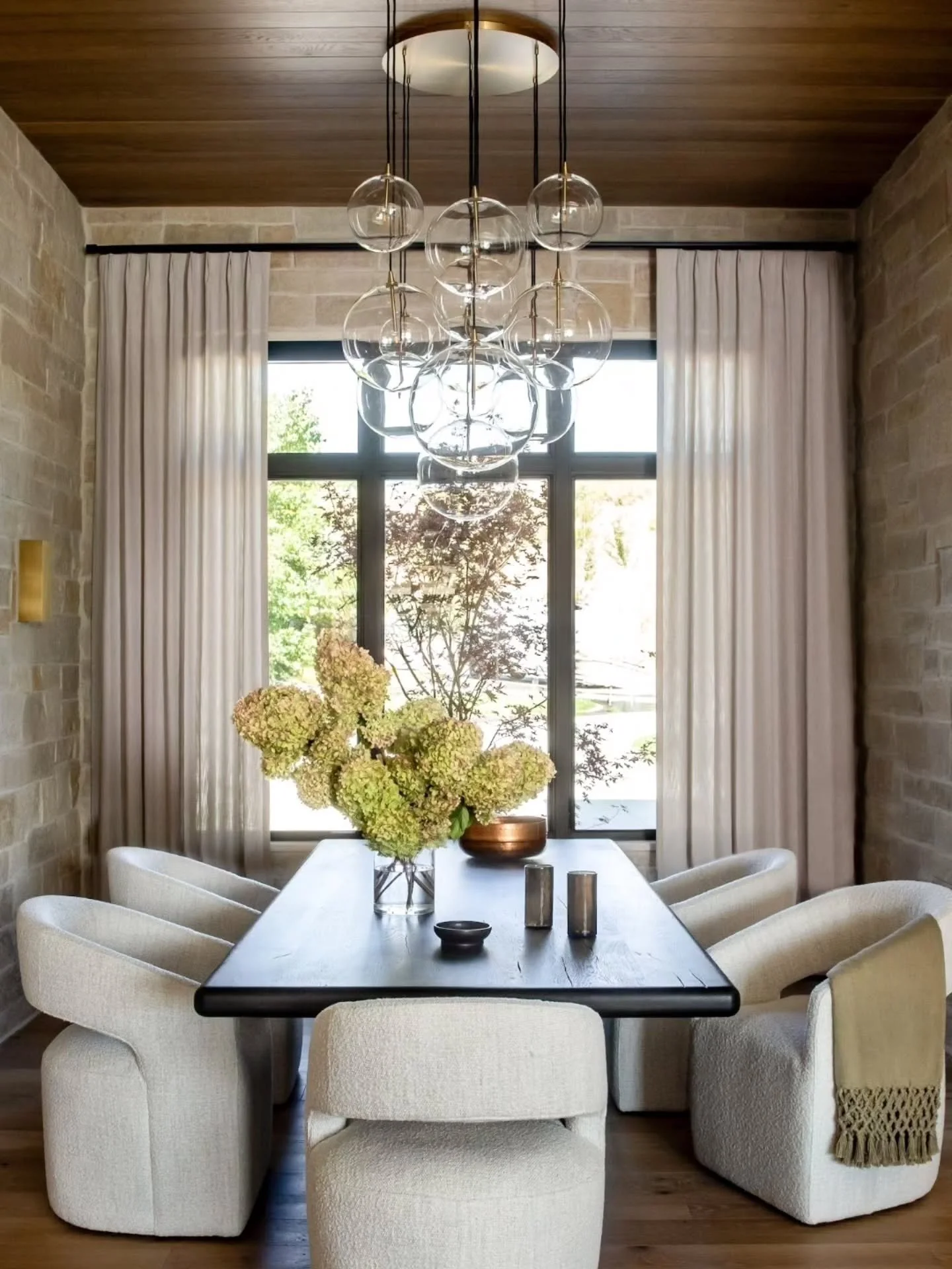 Let's just talk about what makes this room so special...
Is it the stone? 
The wood ceiling and beams? 
Is it the comfortable chairs and gorgeous table? Maybe it's the drapes? 

Well, if you said any of those, you are right. 
It's the combo of all of