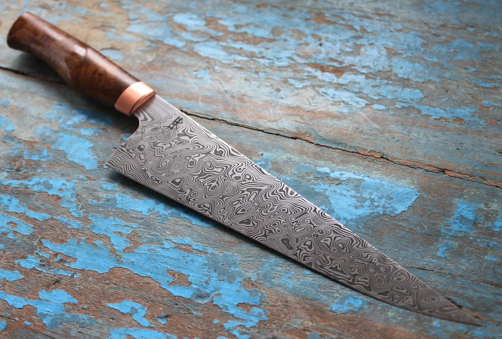Damasteel chef's knife, teak burl and copper handle