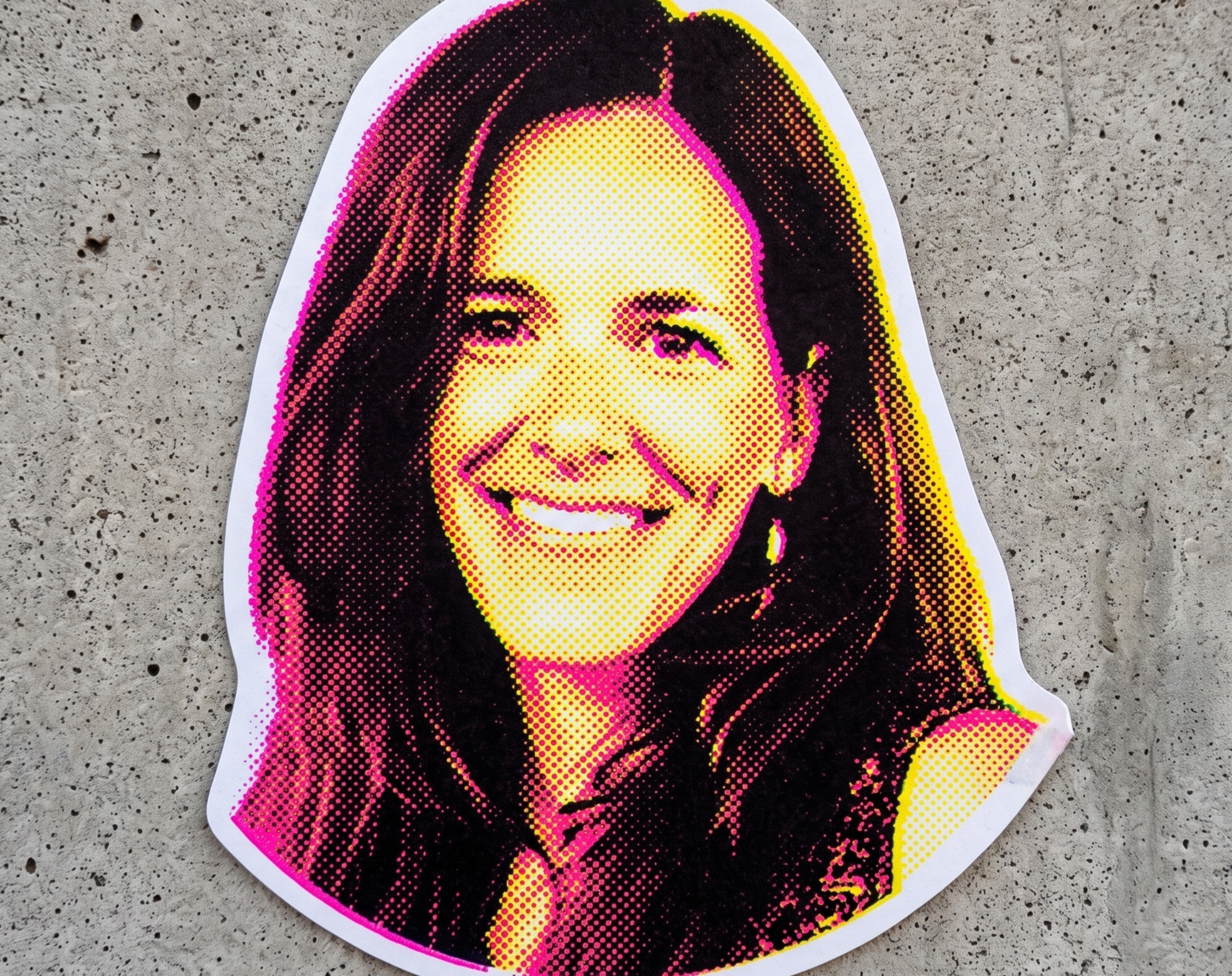Colorful poster of a woman smoking with a pink, yellow, and black dotted art style, on a concrete surface.