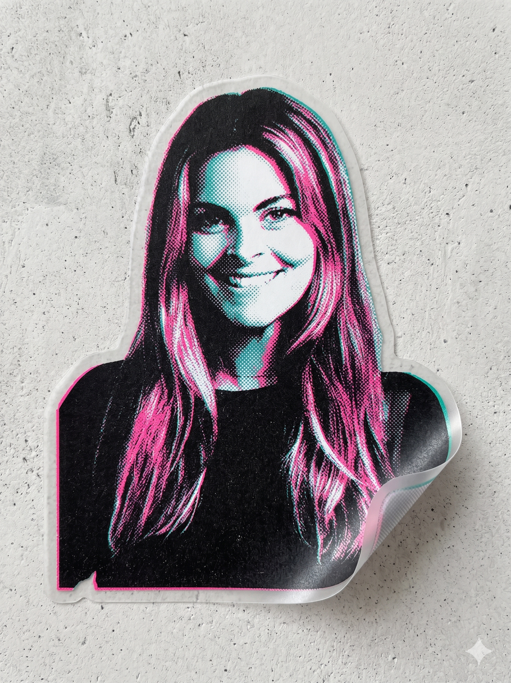 A sticker of a woman's face with pink and teal hair, winking and smiling, on a white textured surface.