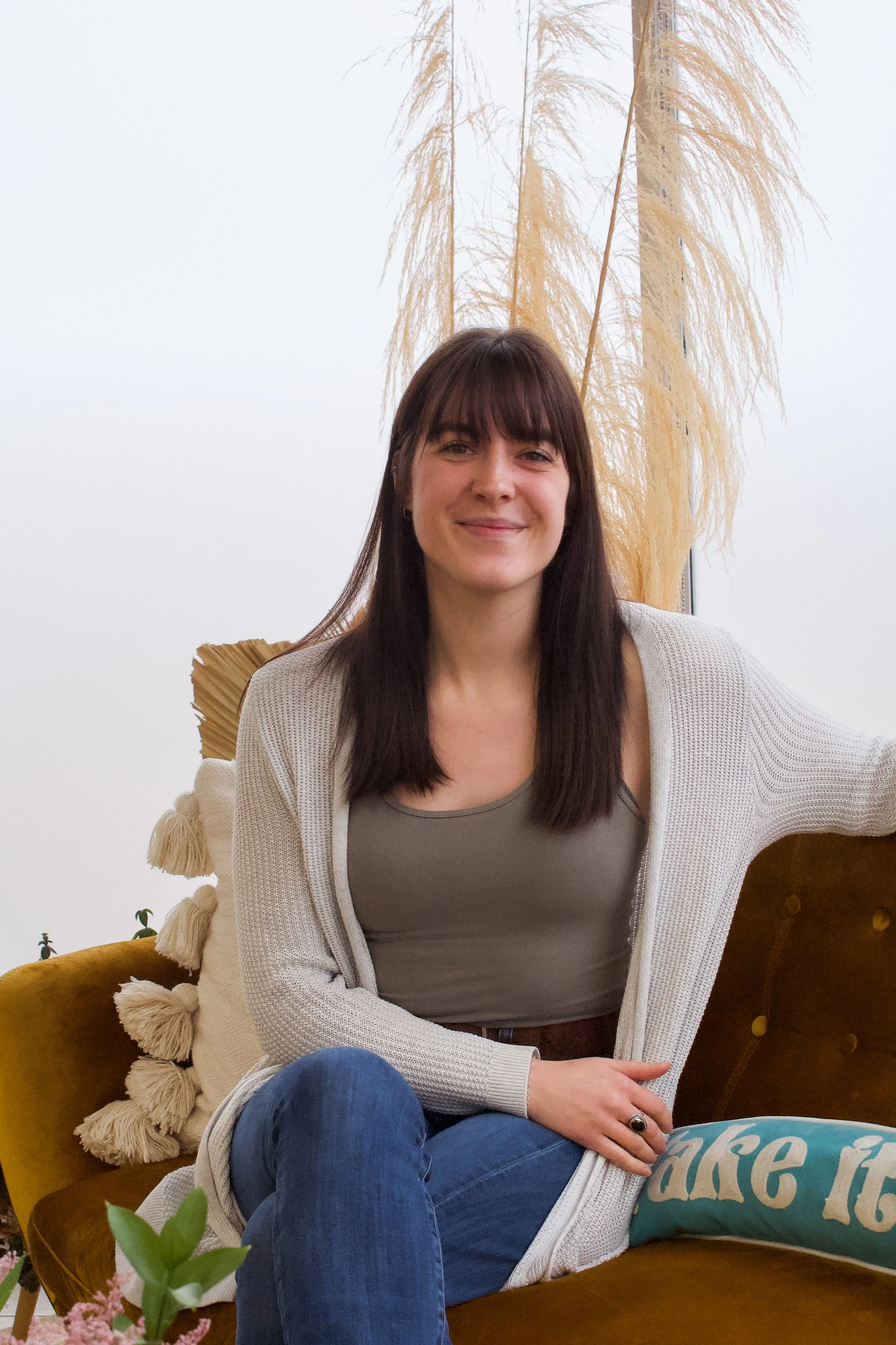 Em, Prairie and Luna’s accessory buyer and marketing manager, relaxing on the store’s signature gold velvet couch.