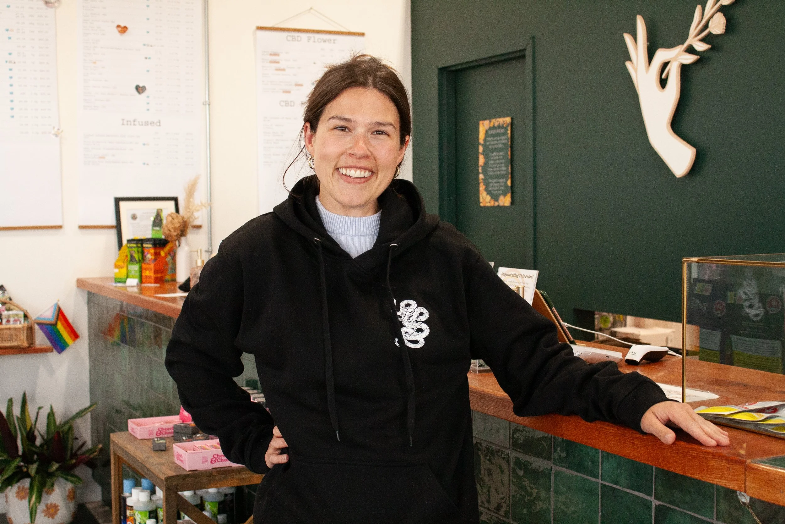 Kayla, Prairie and Luna’s marketing and project manager, beaming behind the counter in her website profile photo.