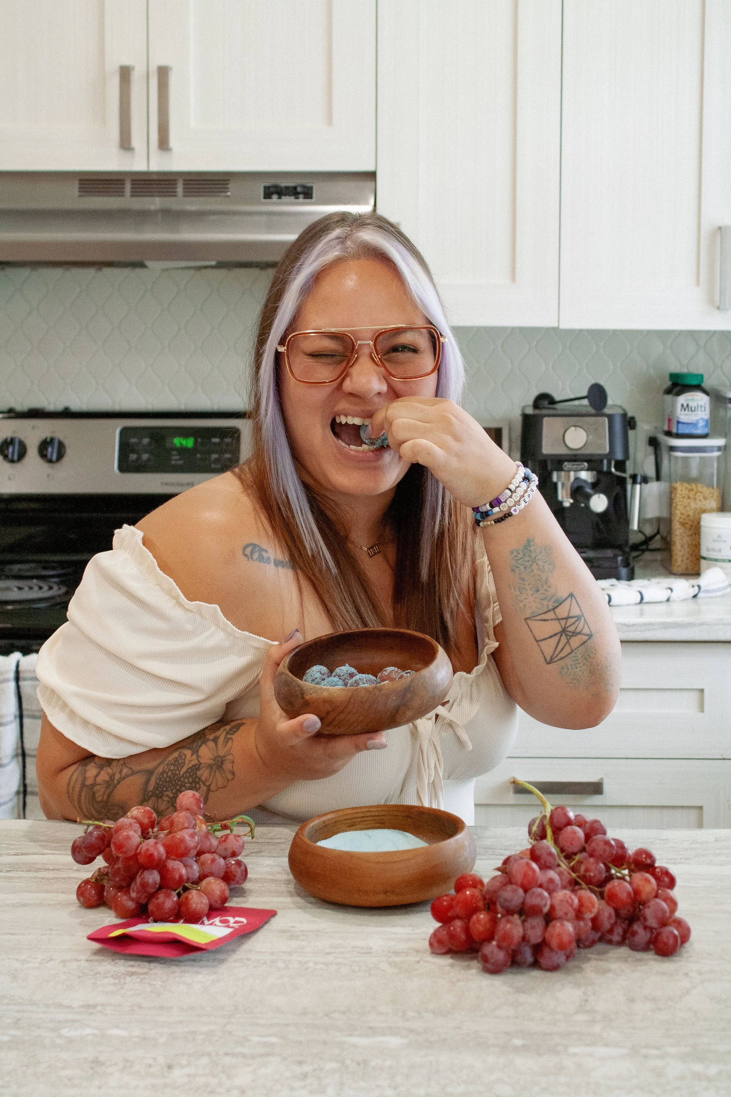 Paula, Prairie and Luna budtender and culinary grad, playfully showing off her cannabis-infused sugared grape.