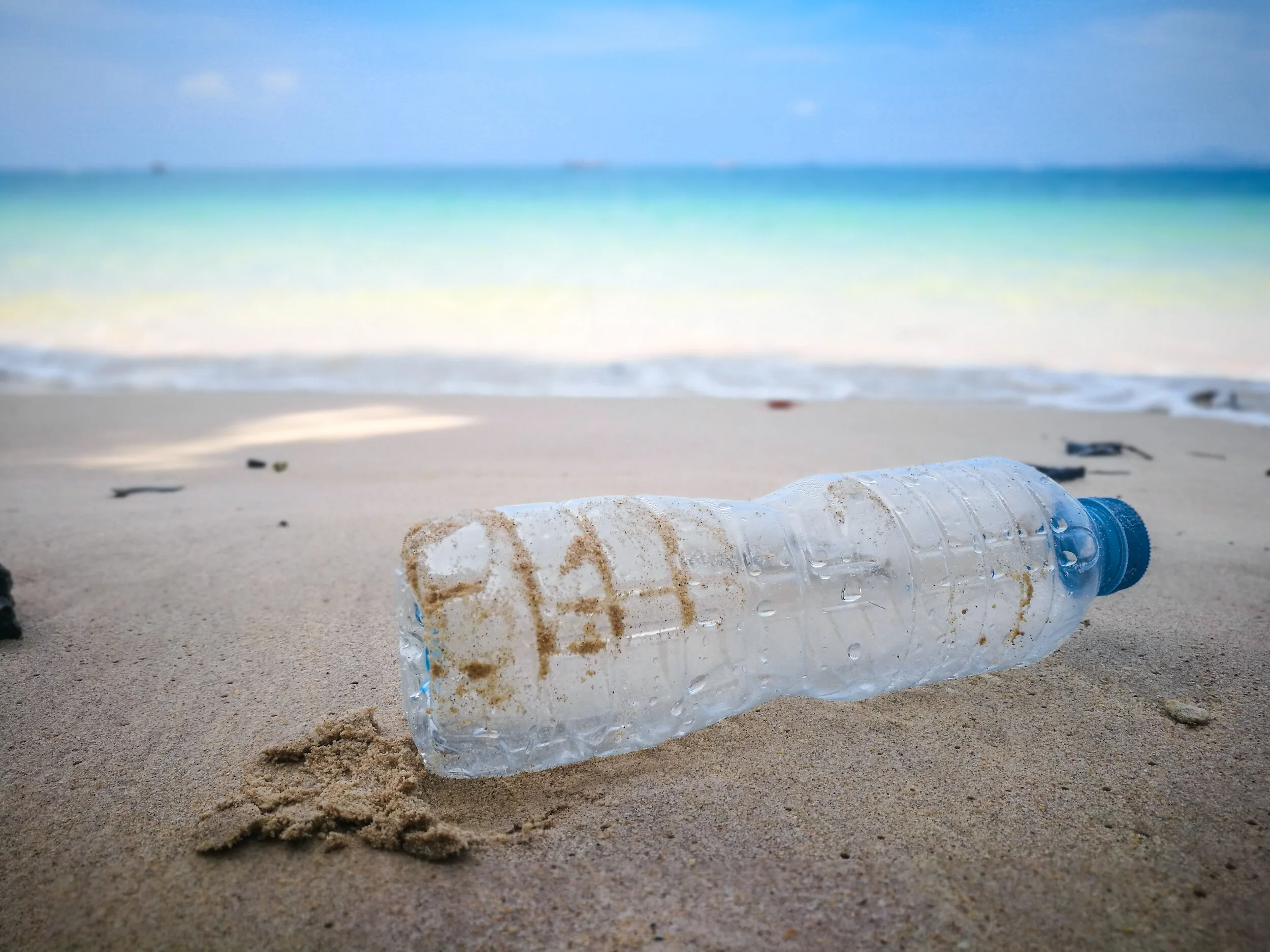 shutterstock_1375935599 bottle on beach.jpg