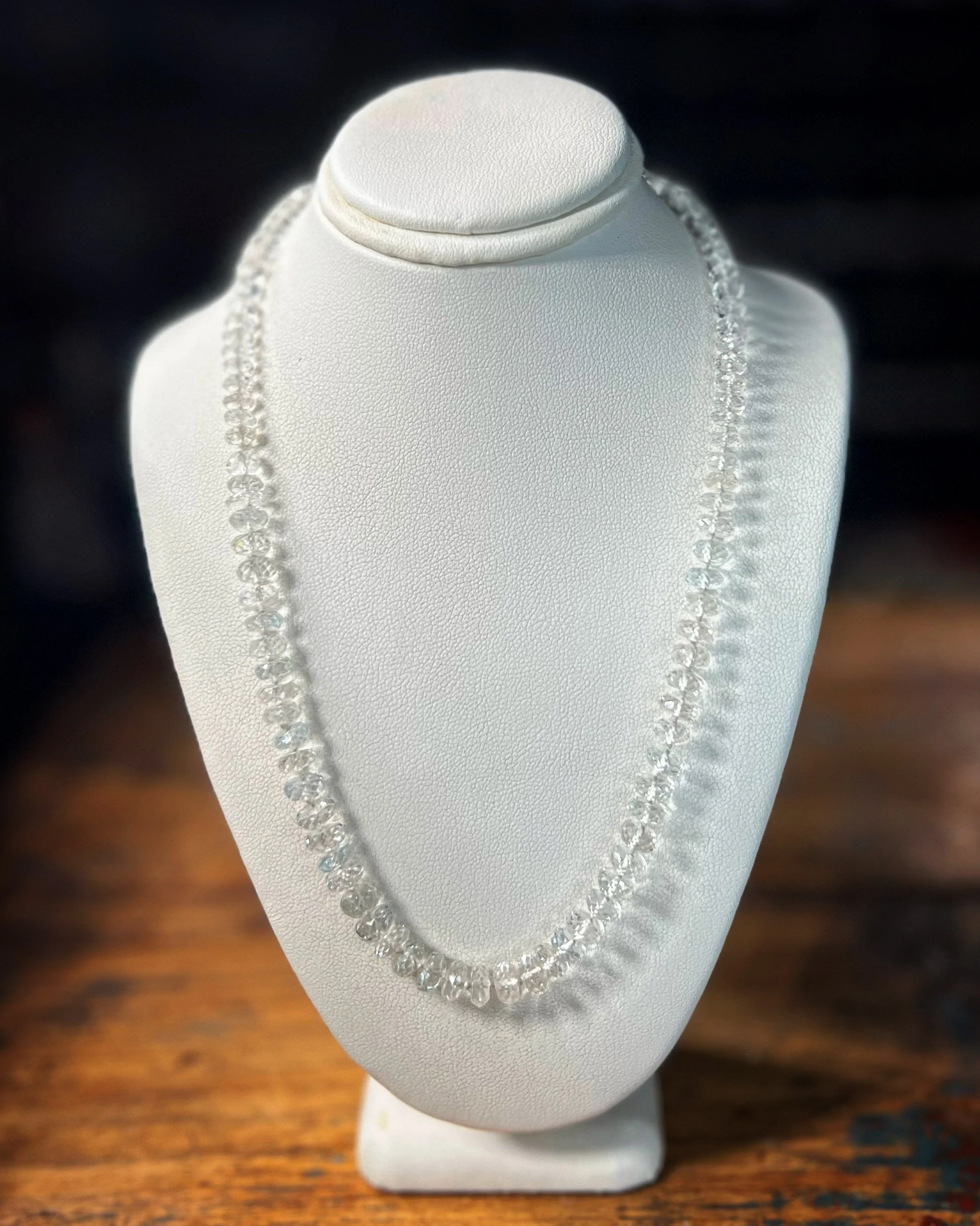 White topaz necklace displayed on a white jewelry bust