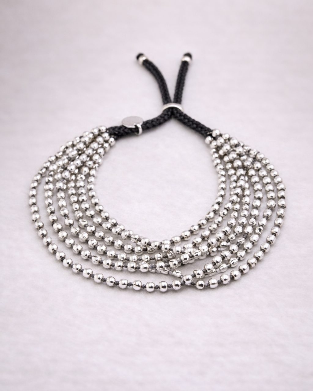Silver-9-Strand-Bracelet-Product-Shot.png