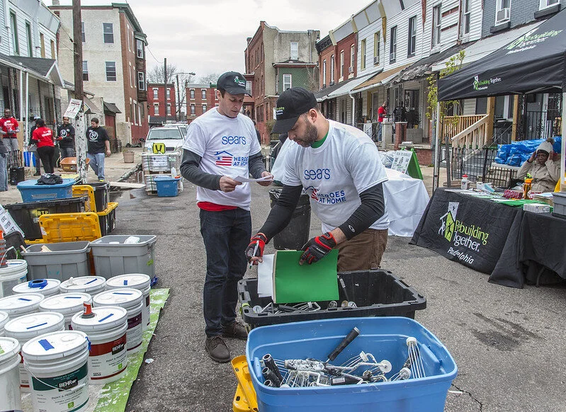 Two skilled leaders look through crates and take inventory at a Block Build.