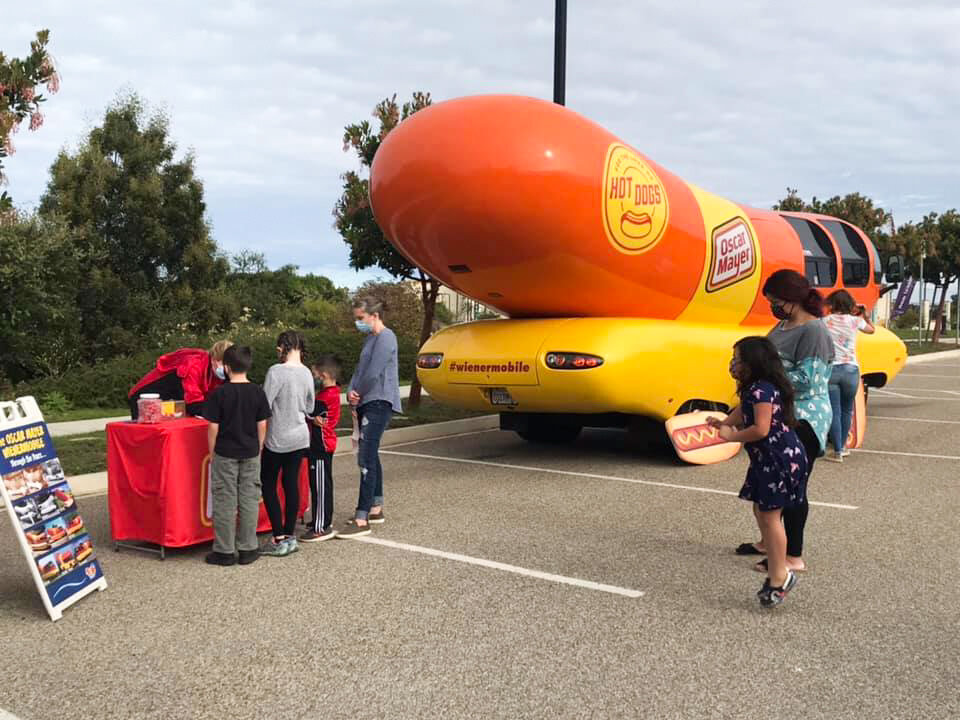 The Weenie Mobile makes its rounds, handing out hot dogs to our community members.  