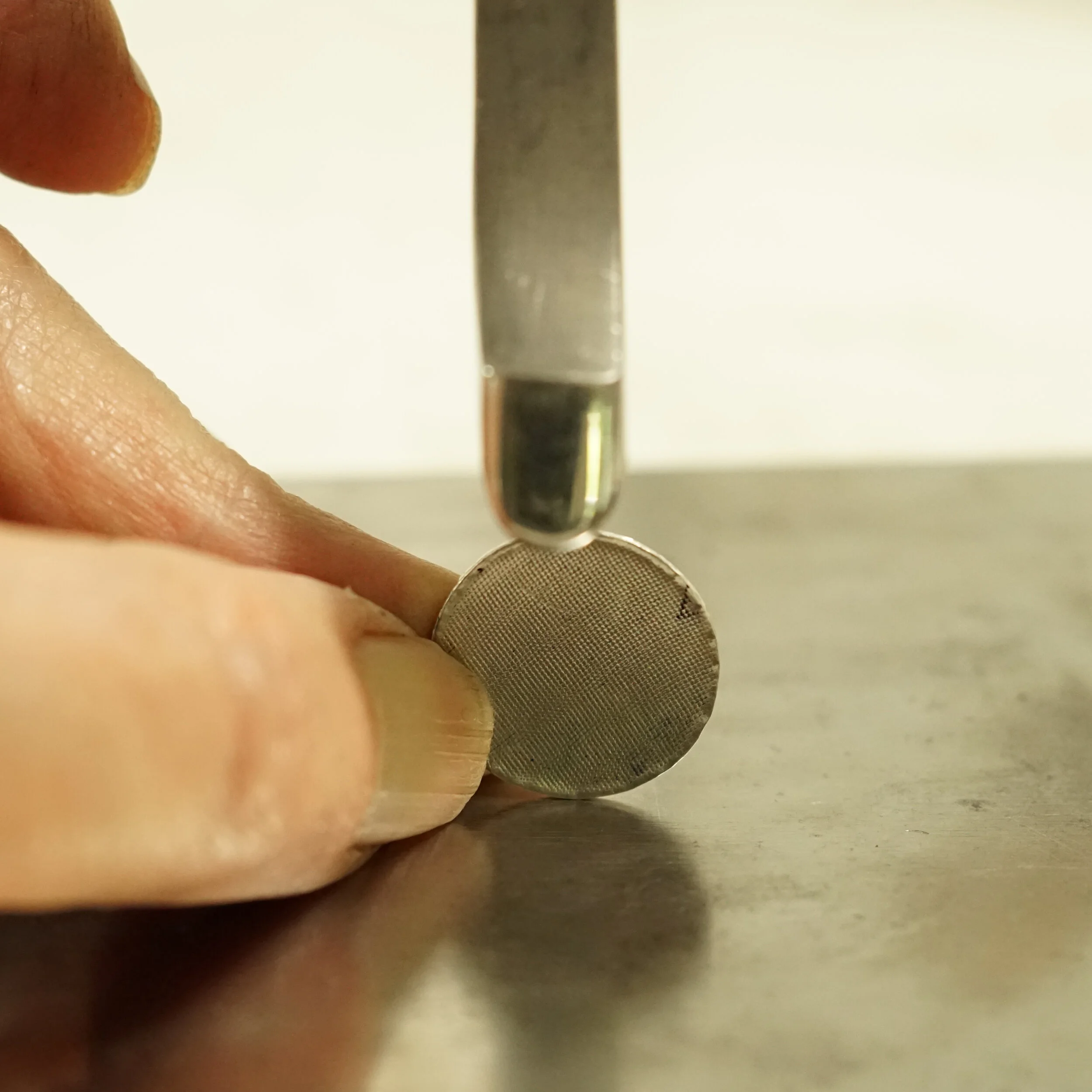 strike the top of disc, directly opposite where it touches bench block