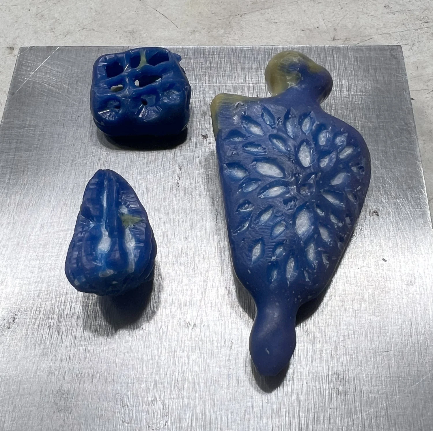 wax models with white core showing unside the blue shell wax