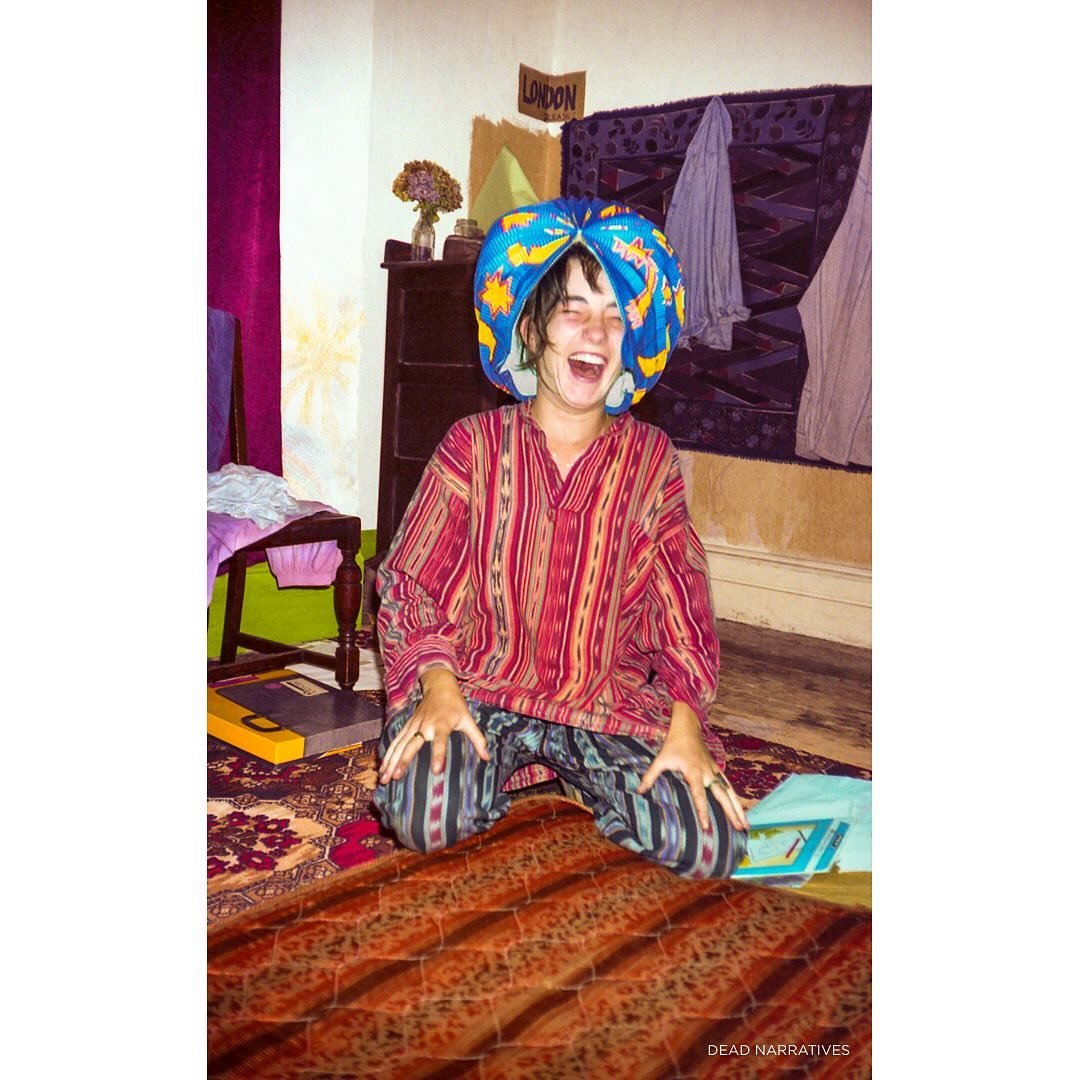 Steph wearing a lamp shade and having a grand laugh in my room at the squat in London. UK, 1990.

**