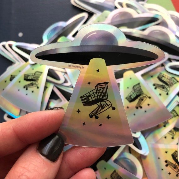 Cool Iridescent Shopping Cart Alien Abduction Illustrated Iridescent Silver Sticker. Two And A Half Inches Size.