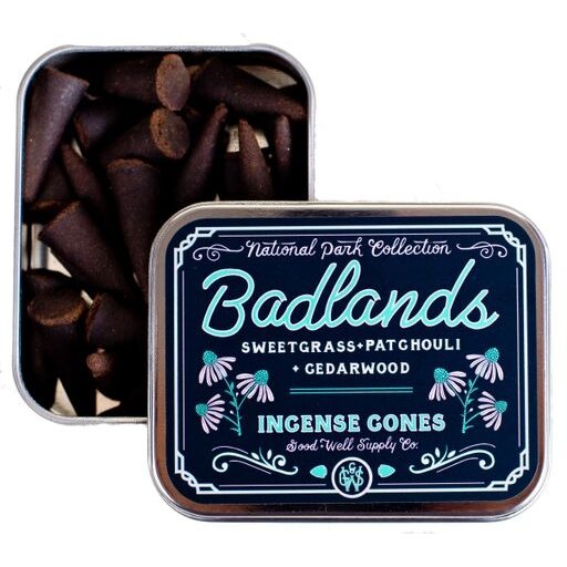 Image Of Badlands Cone Incense (Cedarwood, Sweetgrass and Patchouli) In A Decorative Metal Tin With “Badlands” in Script Type With Small Flowers and Swirl Accents. 25 Pieces Per Tin.