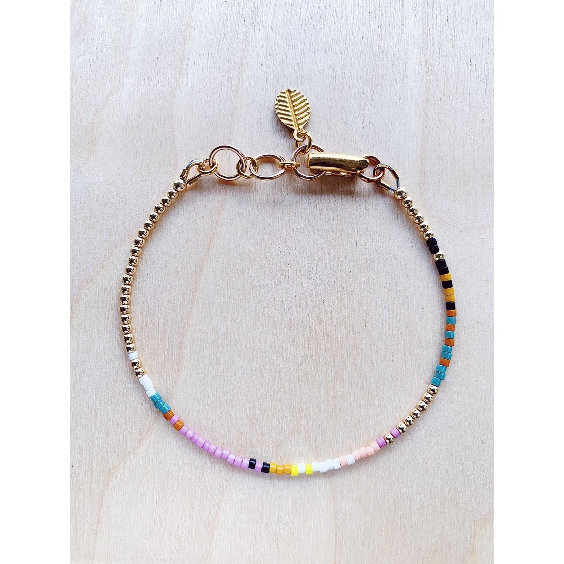 Image Of Beaded Bracelet With Lilac Flower Inspired Colors: Pastel Lilac Purple, Yellow, Orange, White, Deep Turquoise And Metallic Gold