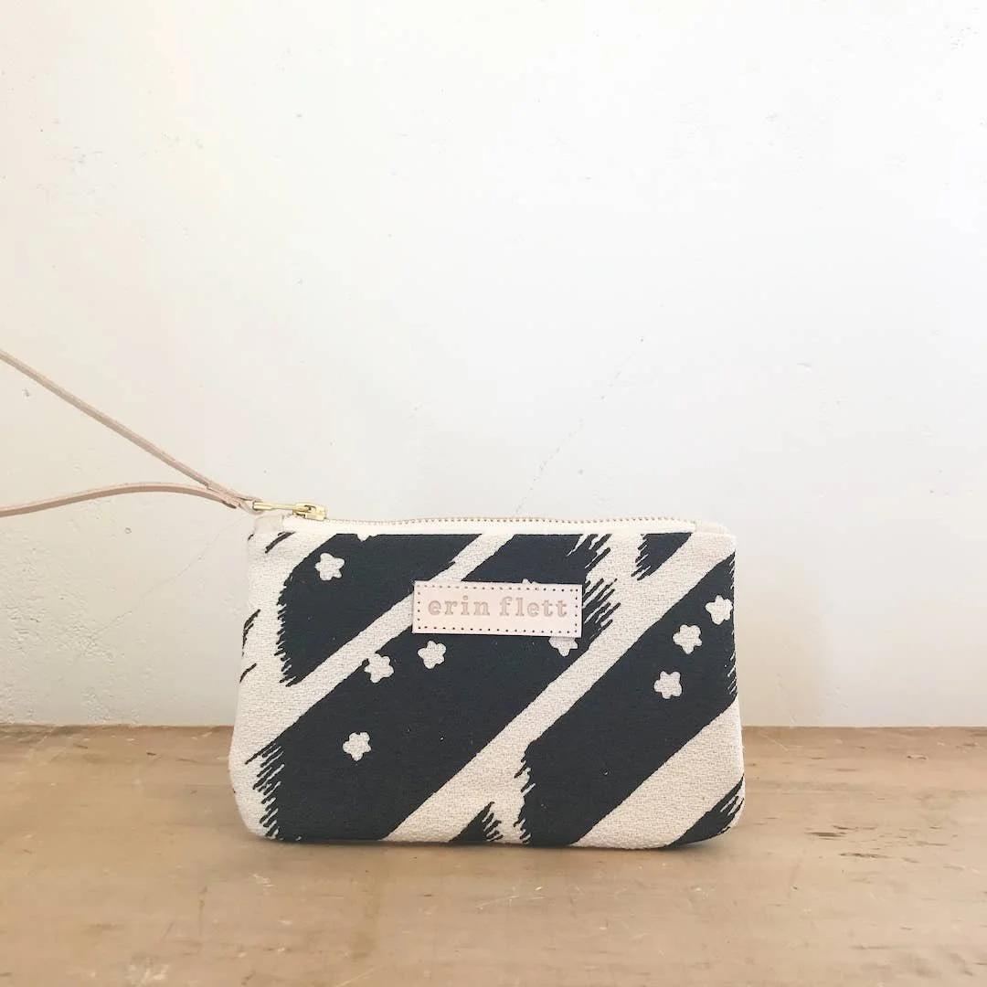 Image Of Erin Flett Black Flying Carpet Wristlet In Black Reverse Image Stars Print With Natural Leather Wrist Strap And Label. Sceenprinted Fabric Purse.