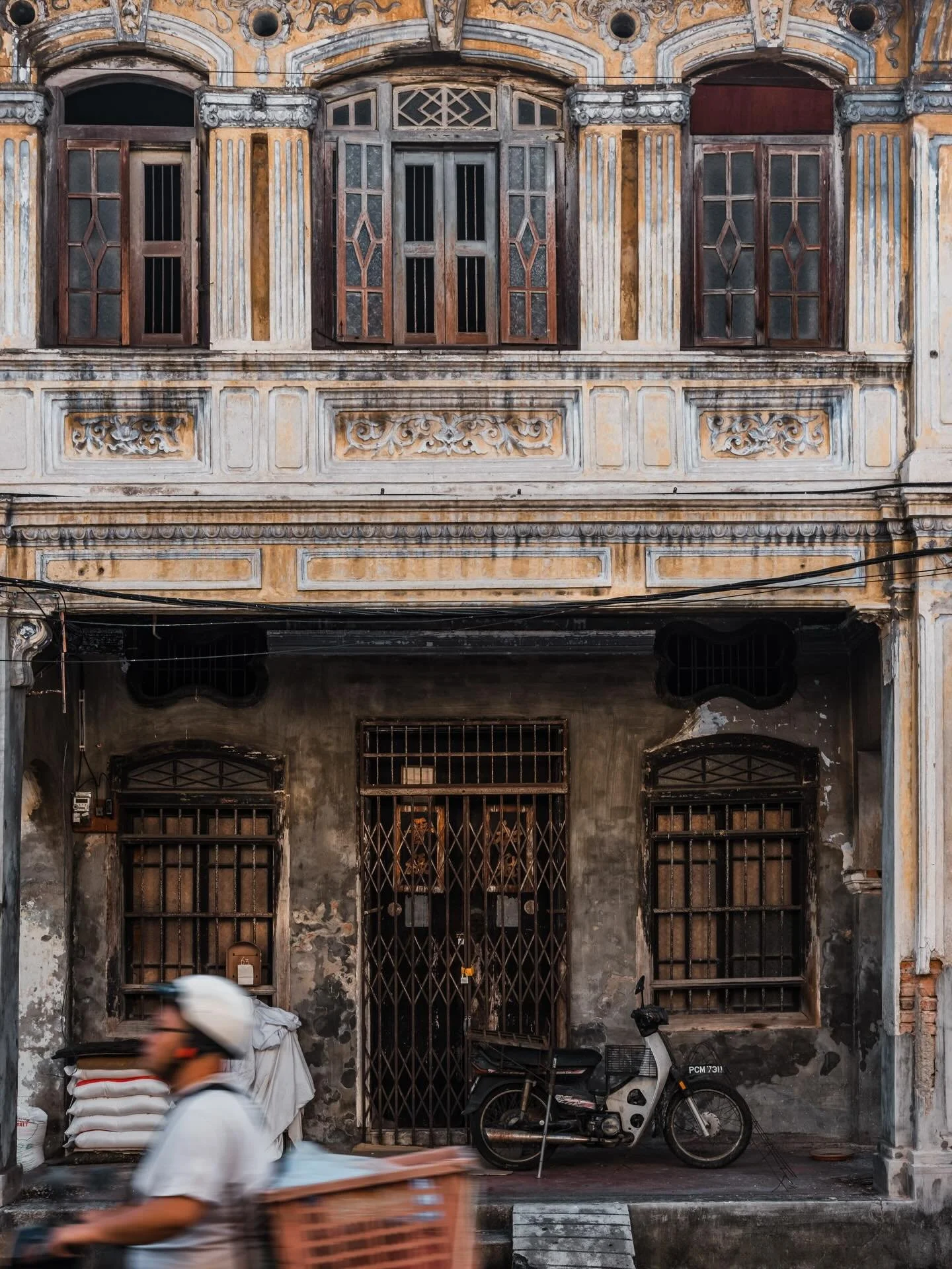 Chinese shop houses and motorbikes. George Town, Malaysia. January 2026.