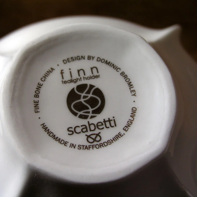 Tealight Holder - A white, glazed bone china tealight holder in the Finn design, showing the base of the vessel with a back stamp.
