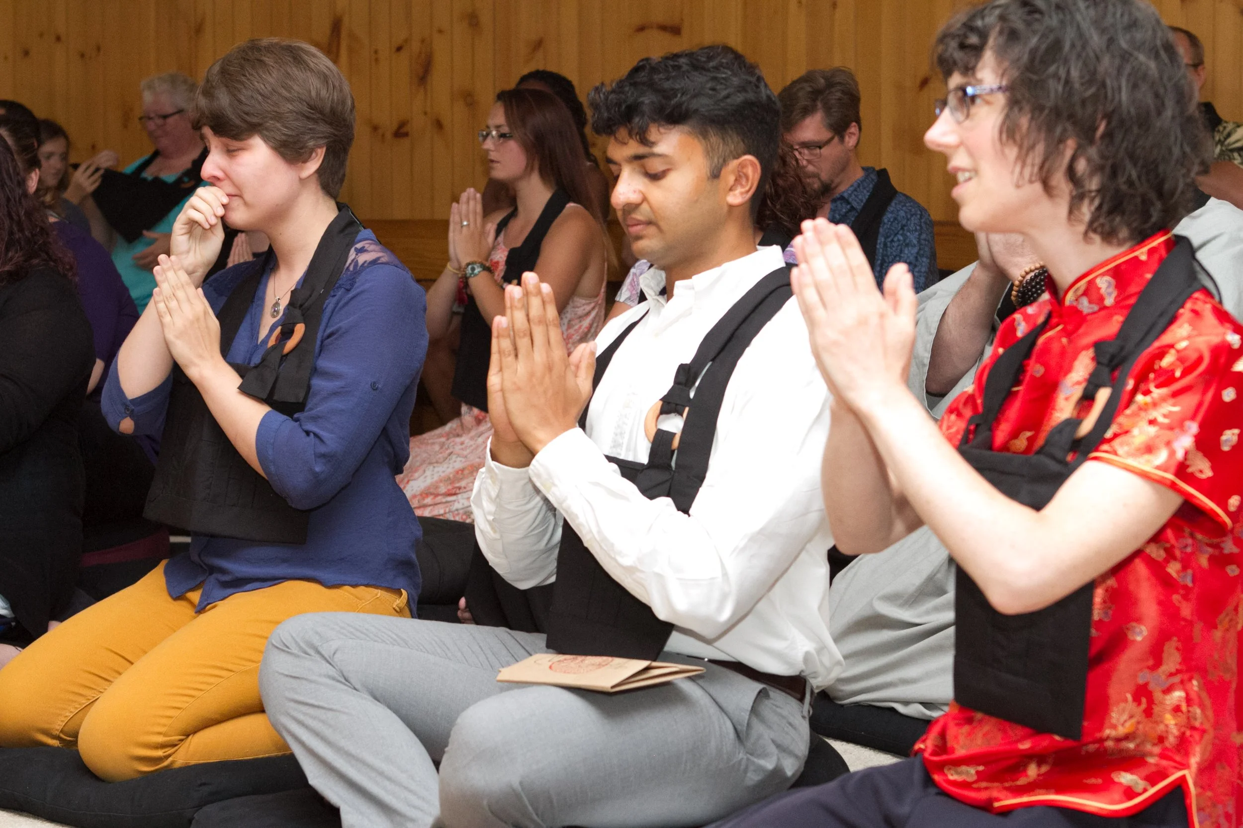 Jukai initiates recite the Verse of the Kesa wearing new rakusu.