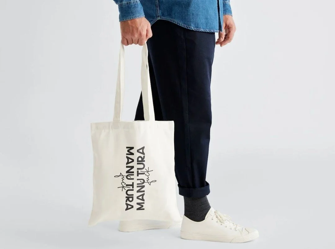 The bag that says what everyone's thinking.\n\nMANUTURA. Fuck. Canvas. White. Bold. Unapologetic.\n\nCarry it to the bakery. To the farmer's market. To anywhere, really. Some people will look twice. Some will smile. Some will ask questions.\n\nThat's