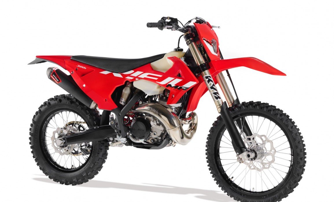 Red off-road motorcycle, side view, with knobby tires and a prominent exhaust pipe.