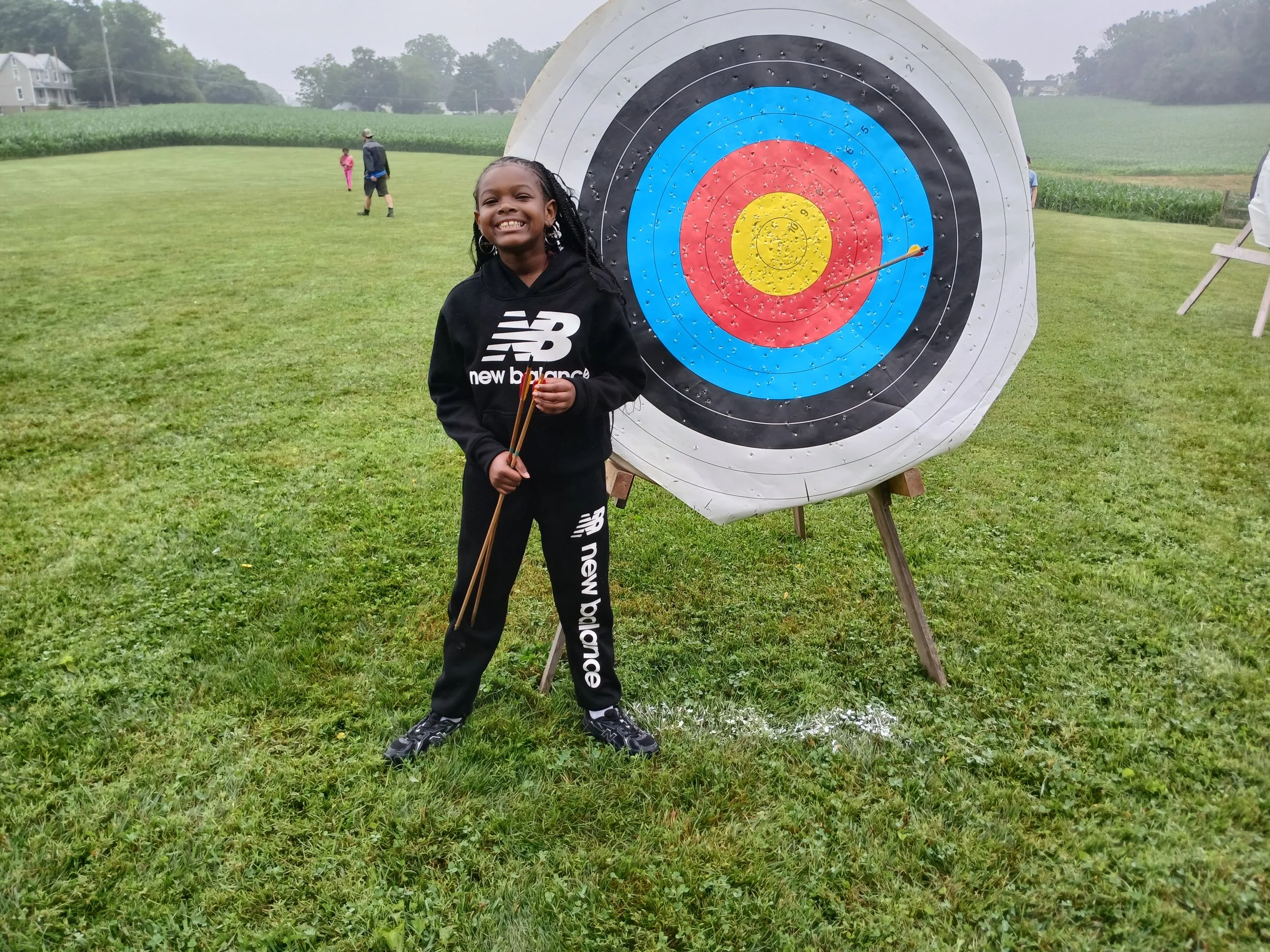 Child participating in an archery activity at Camp Encouragement’s Genesee Valley trip, building confidence and focus during a summer of healing and growth.