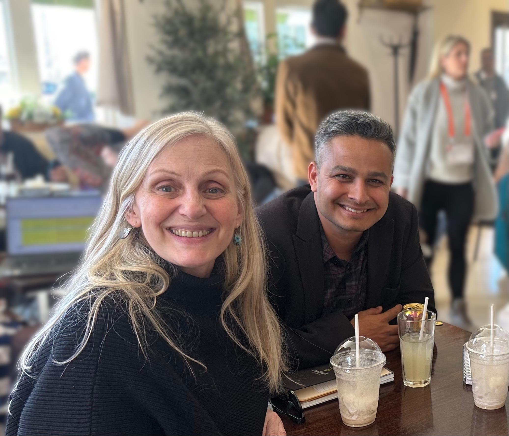 Sibylle Kristensen and Surya Bhatta, Co-CEOs of One Heart Worldwide, smiling together at a table.