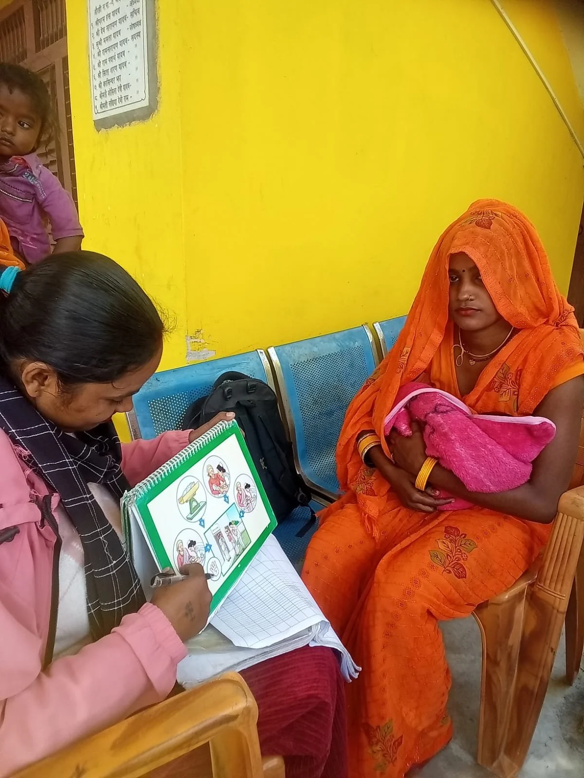 Community Mobilizer counseling a recently delivered woman using easy to understand materials.