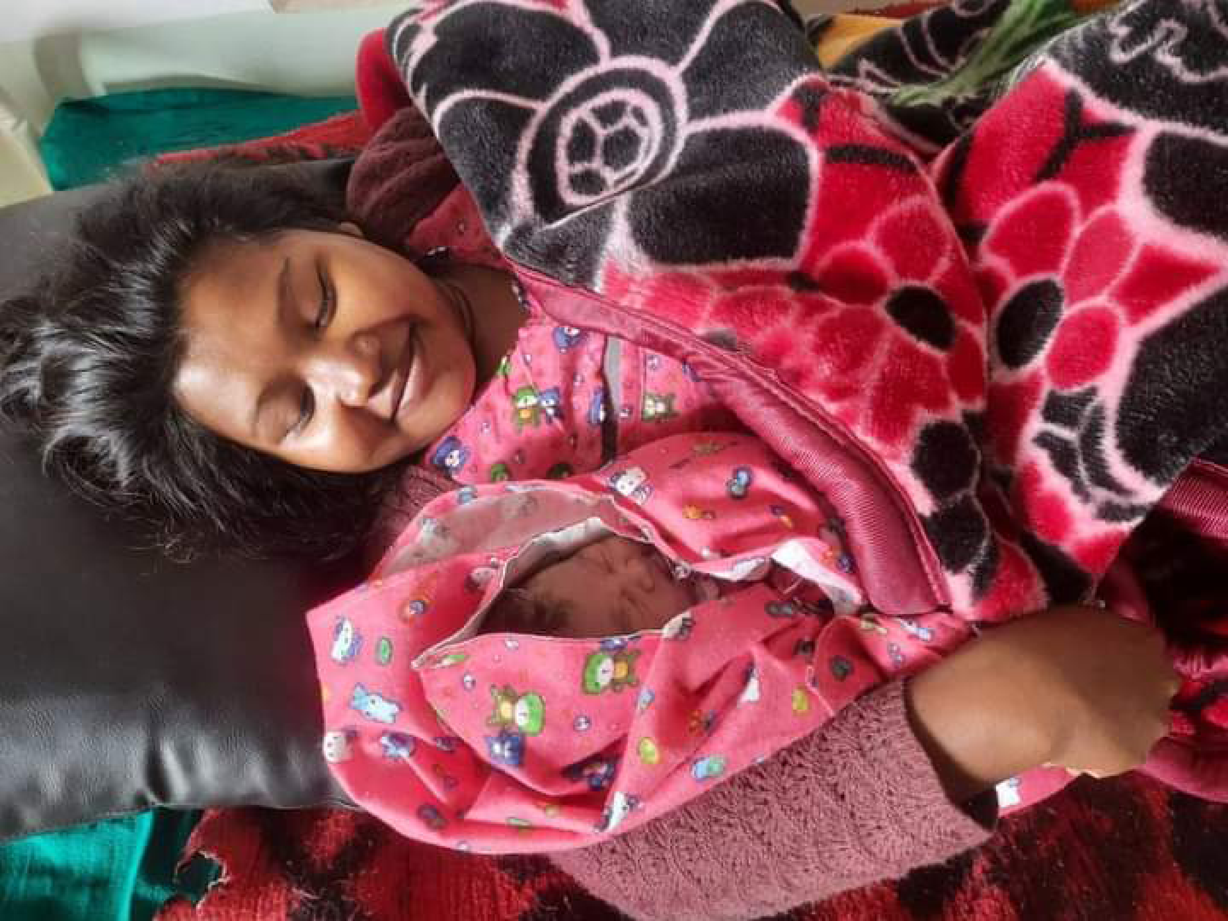 A new mother who just delivered her newborn in an OHW upgraded health facility in Nepal.