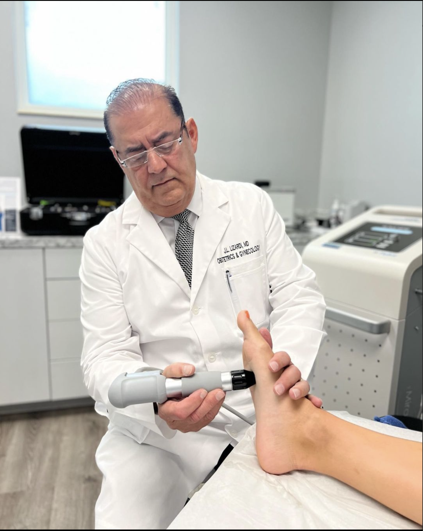 Dr. Jose Lizardi performing sound wave therapy at OMNI LIFE