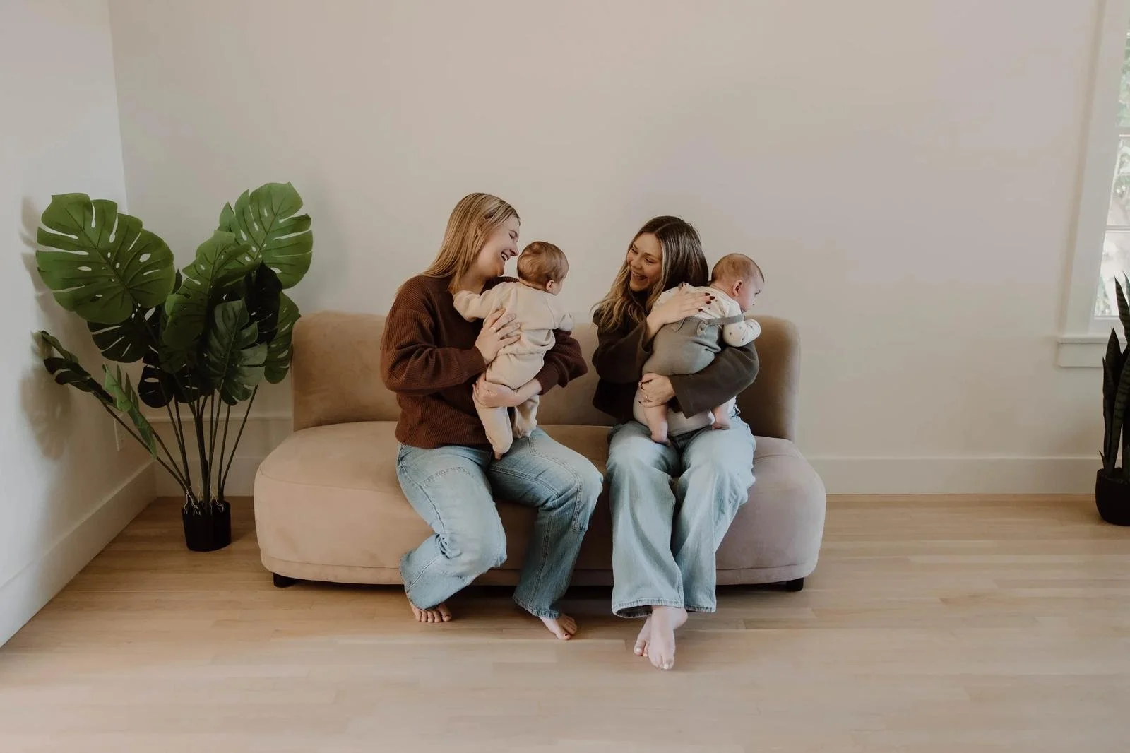 Calm baby in neutral romper resting on cream chiropractic support pillow — infant chiropractic care at Free Spirit Chiropractic in Tulsa