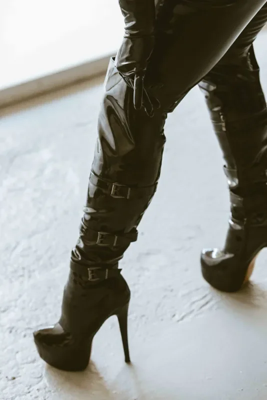Black high-heeled patent leather boot with stiletto heel