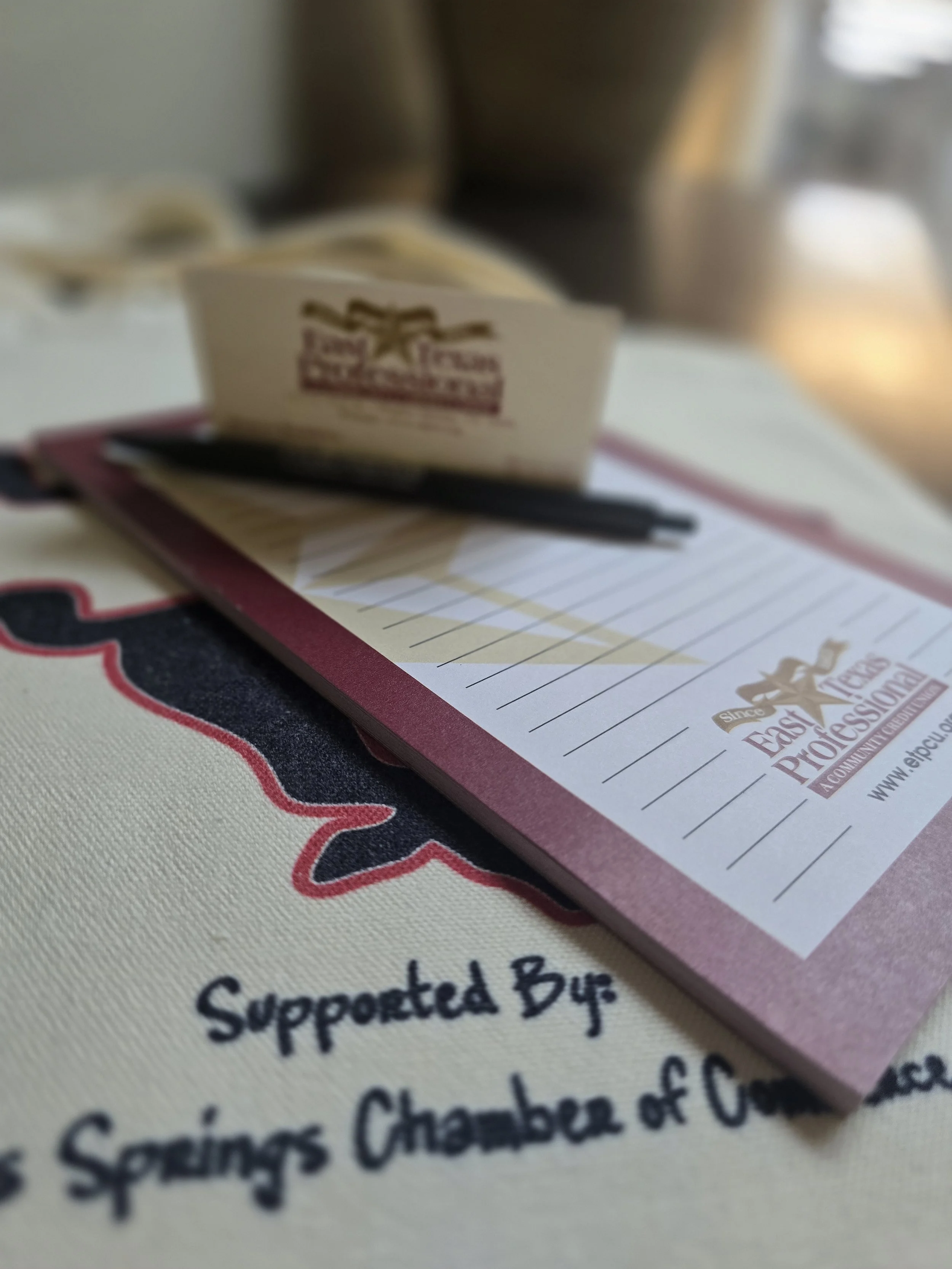 East Texas Professional Credit Union - note pad and pen. ETPCU is ready to help you set up those accounts and discuss other financial needs you have.