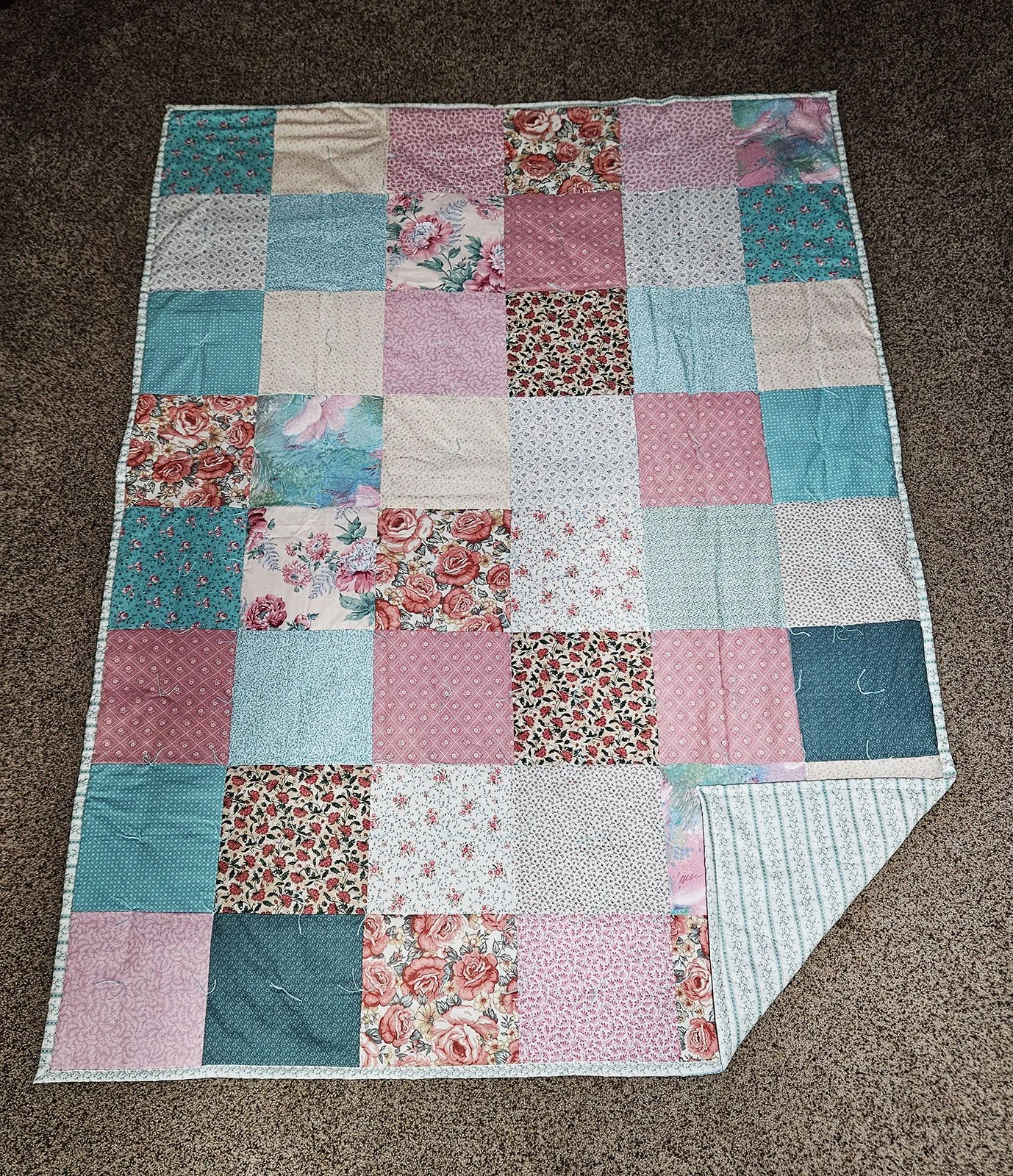 Spring Time Fancy I, Comforter, Lap/Throw, 60x80: Bethesda Women's Ministries, Bethesda Mennonite Church

This tied comforter features patchwork 10" squares in shades of pink, mint and cream.  The backing features mint stripes and flowering vines on 