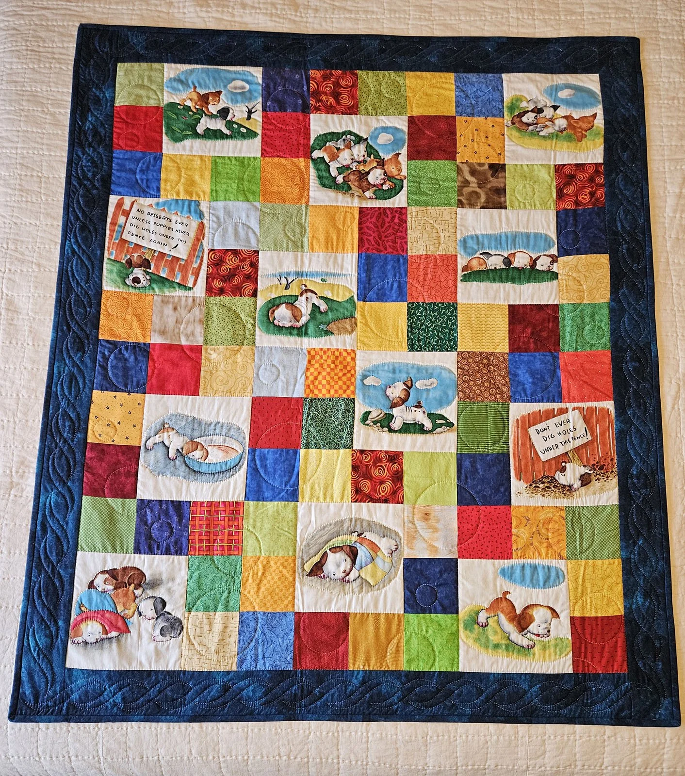 Puppy Love Baby Quilt, 44x54: Material Resources Center of Ephrata, Pa.

The Poky Little Puppy prints are featured in this baby quilt, surrounded by colorful blocks in bright colors and a navy outer border; pieced by Barb Garrett and hand quilted by 