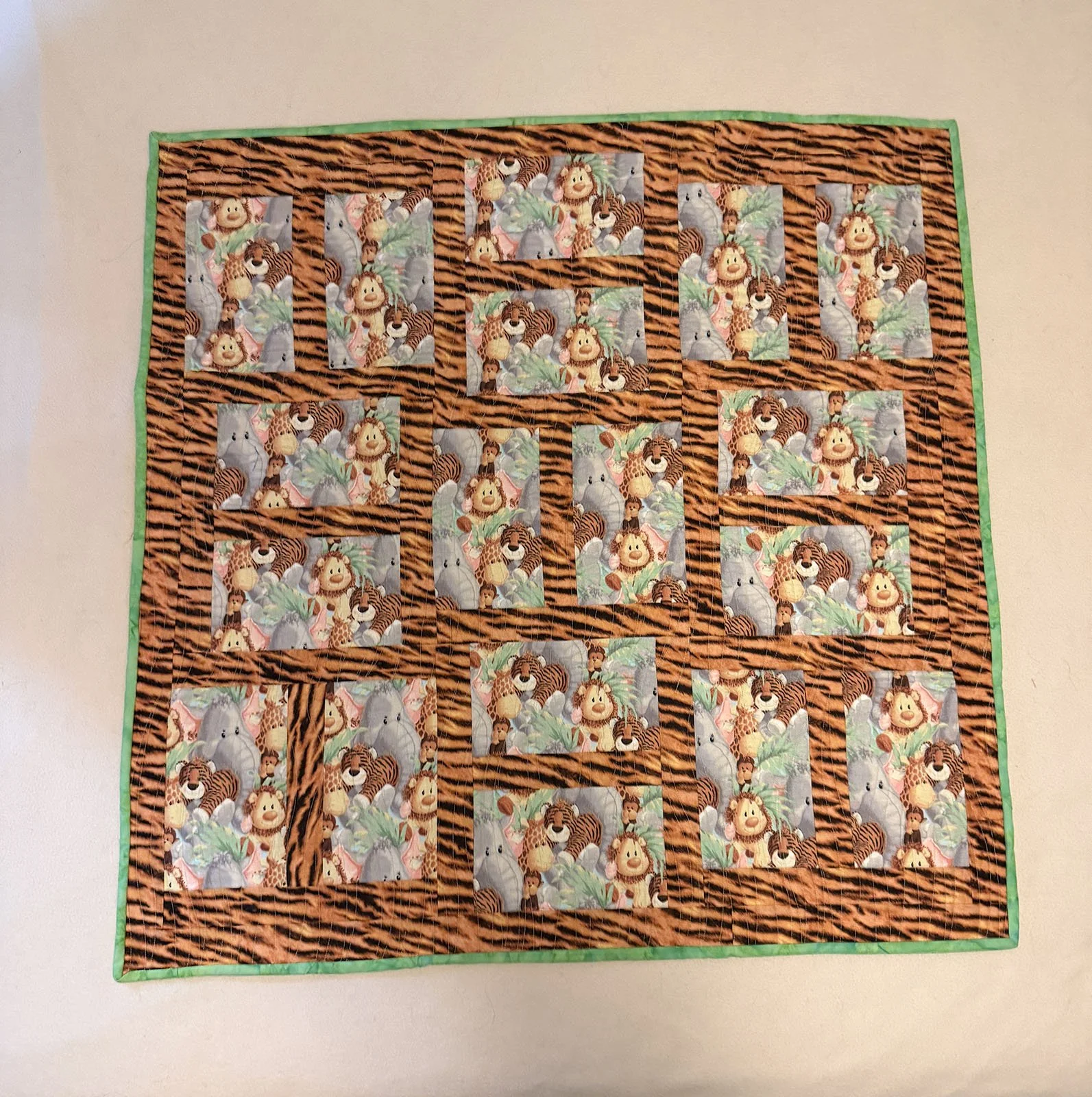 Jungle Fever, Quilt, Baby, 35x35: Kathy Boshart, First Mennonite, Lincoln

This quilt was started by my dear friend and ‘bonus mom’ Phyllis, who made many quilts before dementia took away her gift. Though she can no longer sew, her legacy continues t