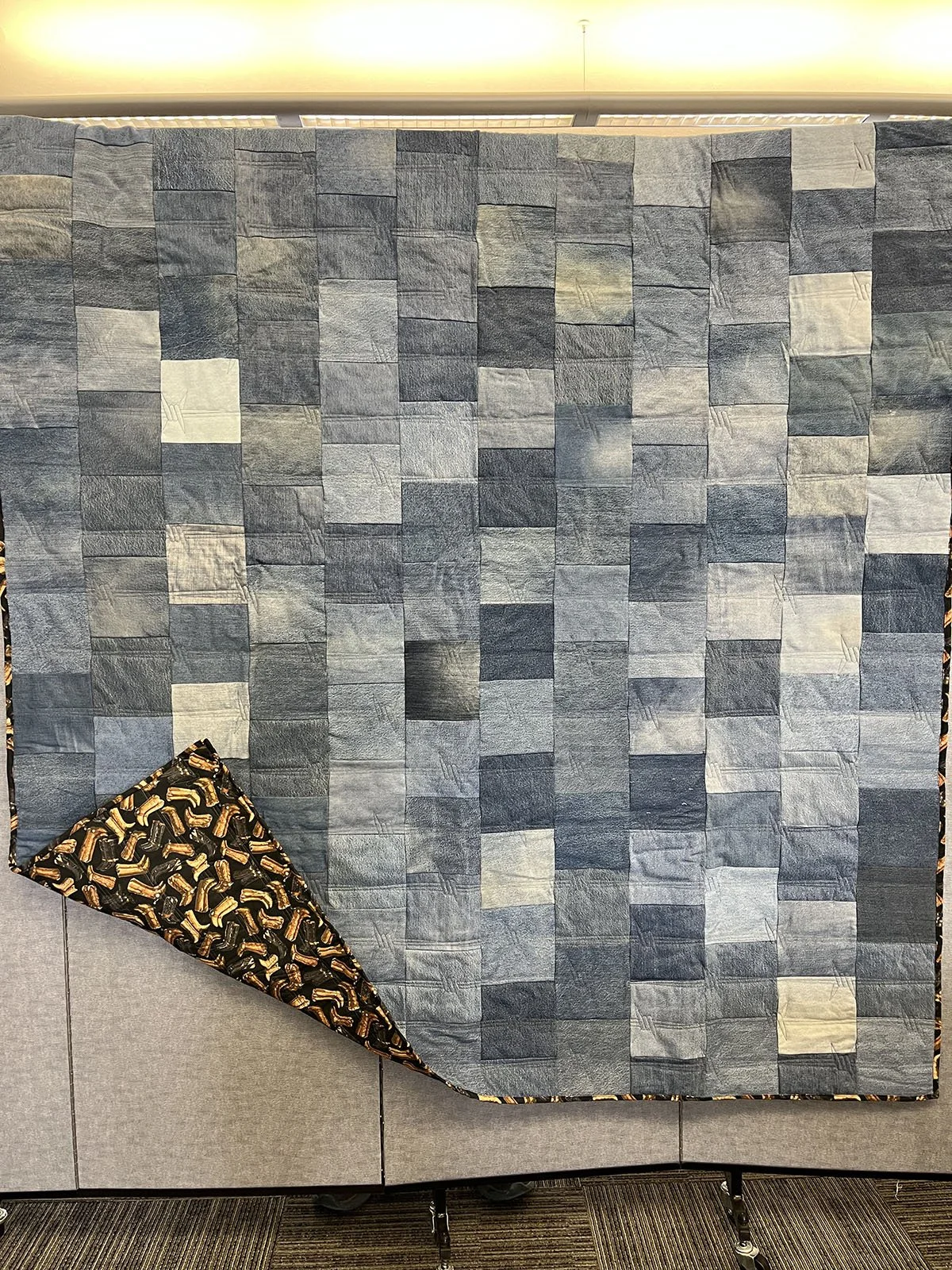 Country Denim, Comforter, Full, 68x84: Marlene Swartzendruber, Salem Mennonite, Shickley

This comforter was made with recycled denim jeans. The backing is cowboy boots in gold and brown. It was machine quilted by Brenda Mesloh using a barbed wire St