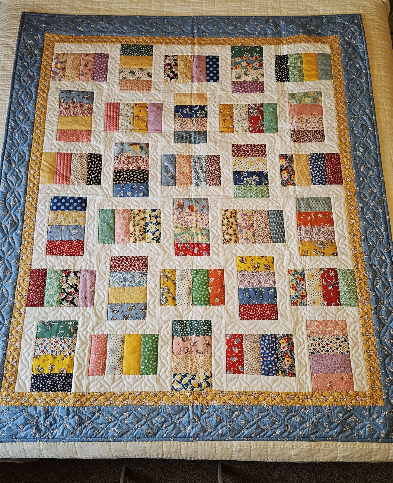 Baby Rails, Baby Quilt, 50x58: Material Resources Center, Ephrata, Pa.

This quilt features 30's reproduction fabric in blue, pink, green, and yellow rails surrounded by borders of white, yellow and blue, pieced by Barb Garrett and quilted by Priscil