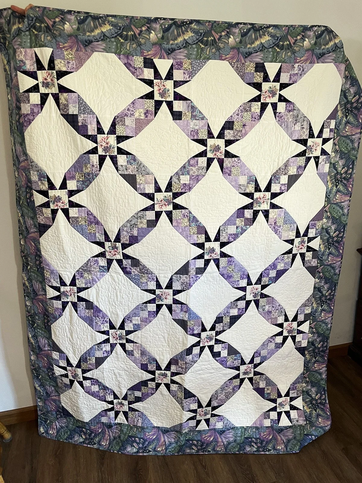 Purple Stars, Quilt, Lap/Throw, 61x78: Vickie Friesen, Bethesda Mennonite Church

Smaller than a twin. Good size for lounging on the couch or a little girl’s room. Pattern designer unknown. Machine pieced, hand quilted. Shades of purple cotton fabric