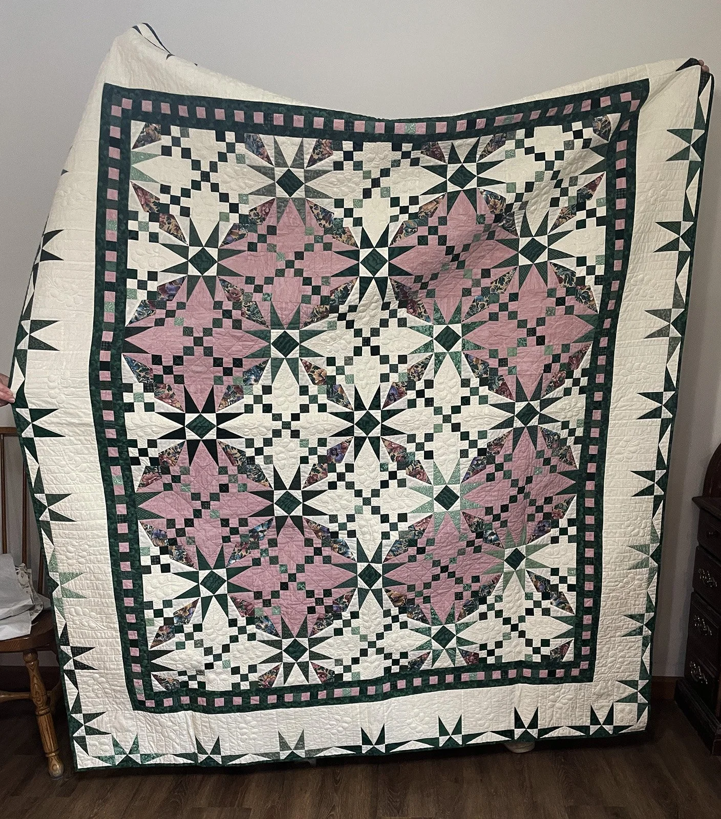 Irish Eyes, Quilt, Lap/Throw, 70x80: Vickie Friesen, Bethesda Mennonite Church

Pink and green quilt, smaller than a twin. Features trapunto quilt design. 
Quilt pattern by Irma Gail Hatcher. Machine pieced and machine quilted.